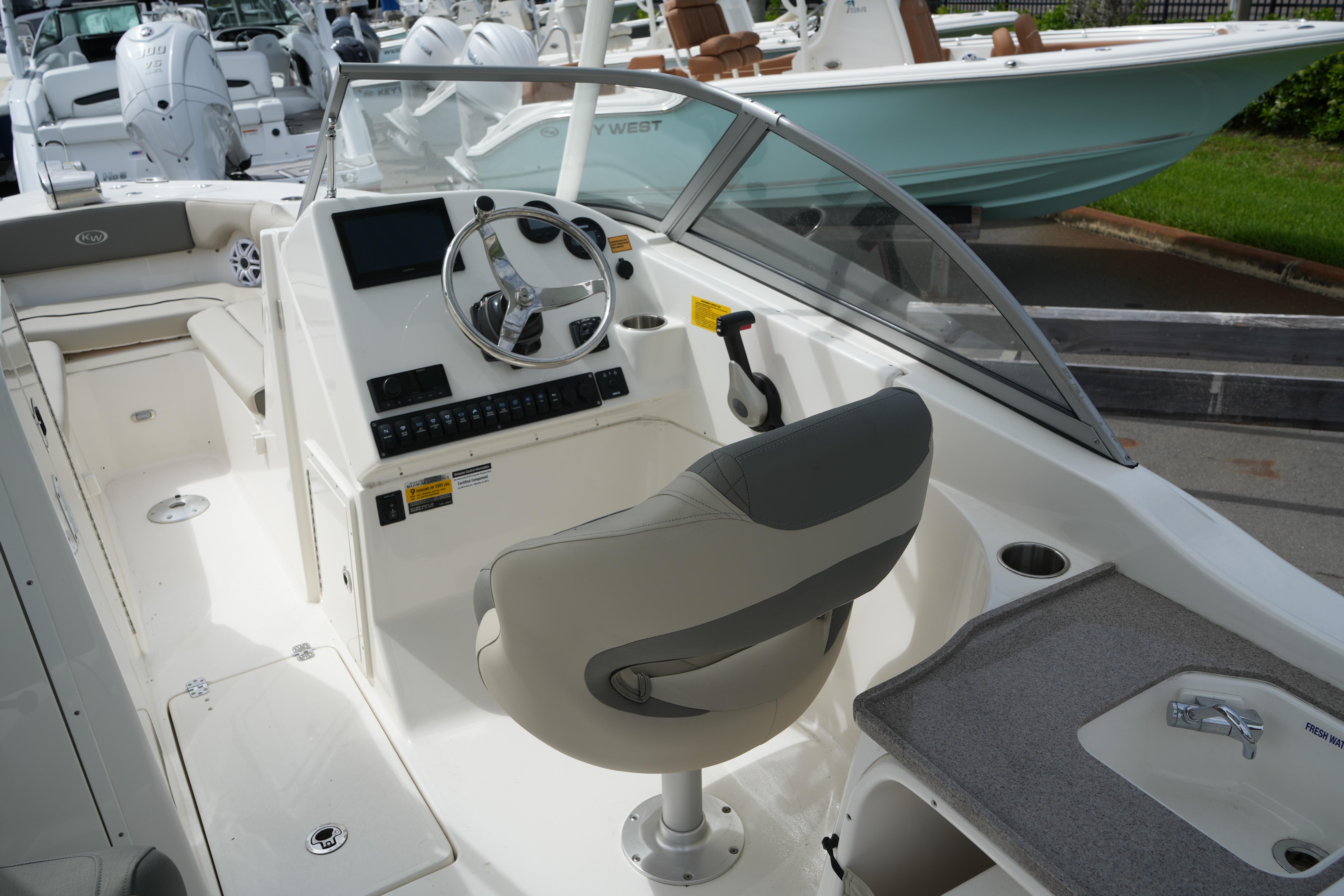 2026 Key West 239 DFS boat interior with steering wheel and seating.