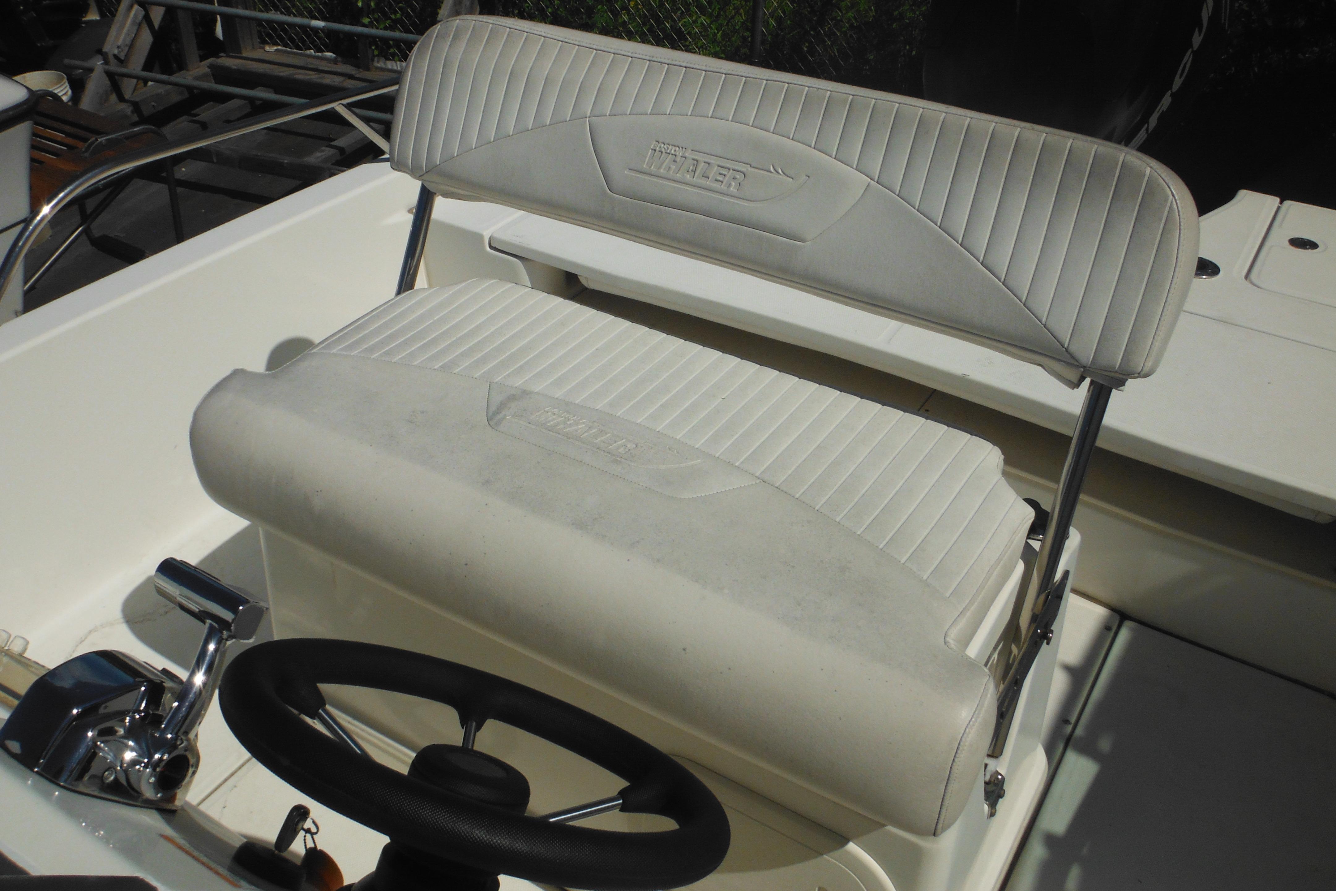 2009 Boston Whaler 200 Dauntless boat interior with steering wheel and seating.