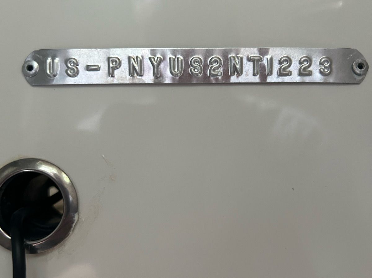 Close-up of a boat hull identification number on a white background.