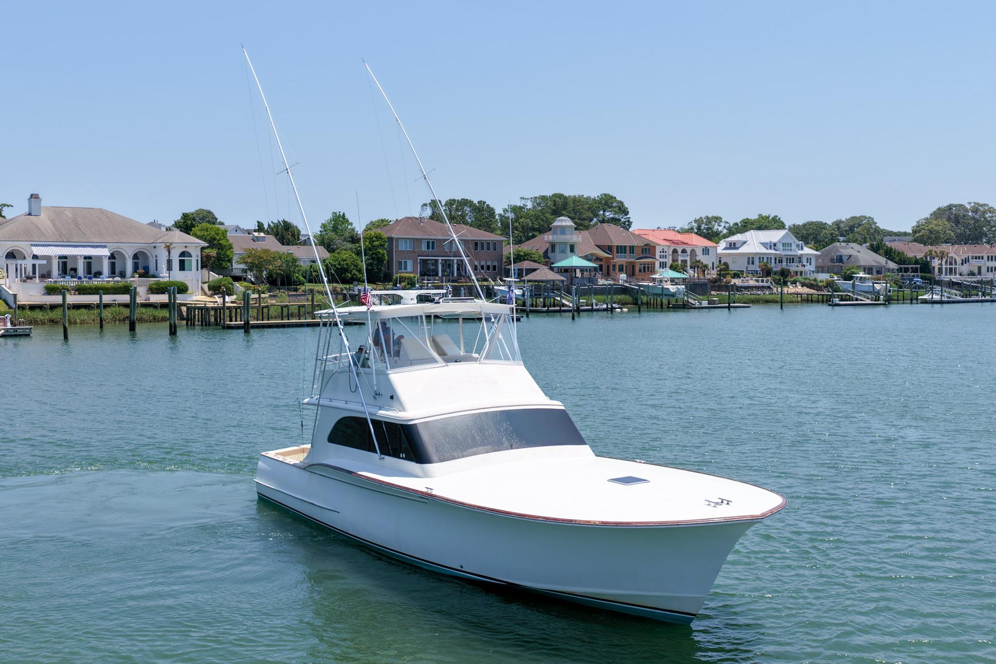 1998 Blackwell Custom Carolina Sportfish boat on water near waterfront homes.