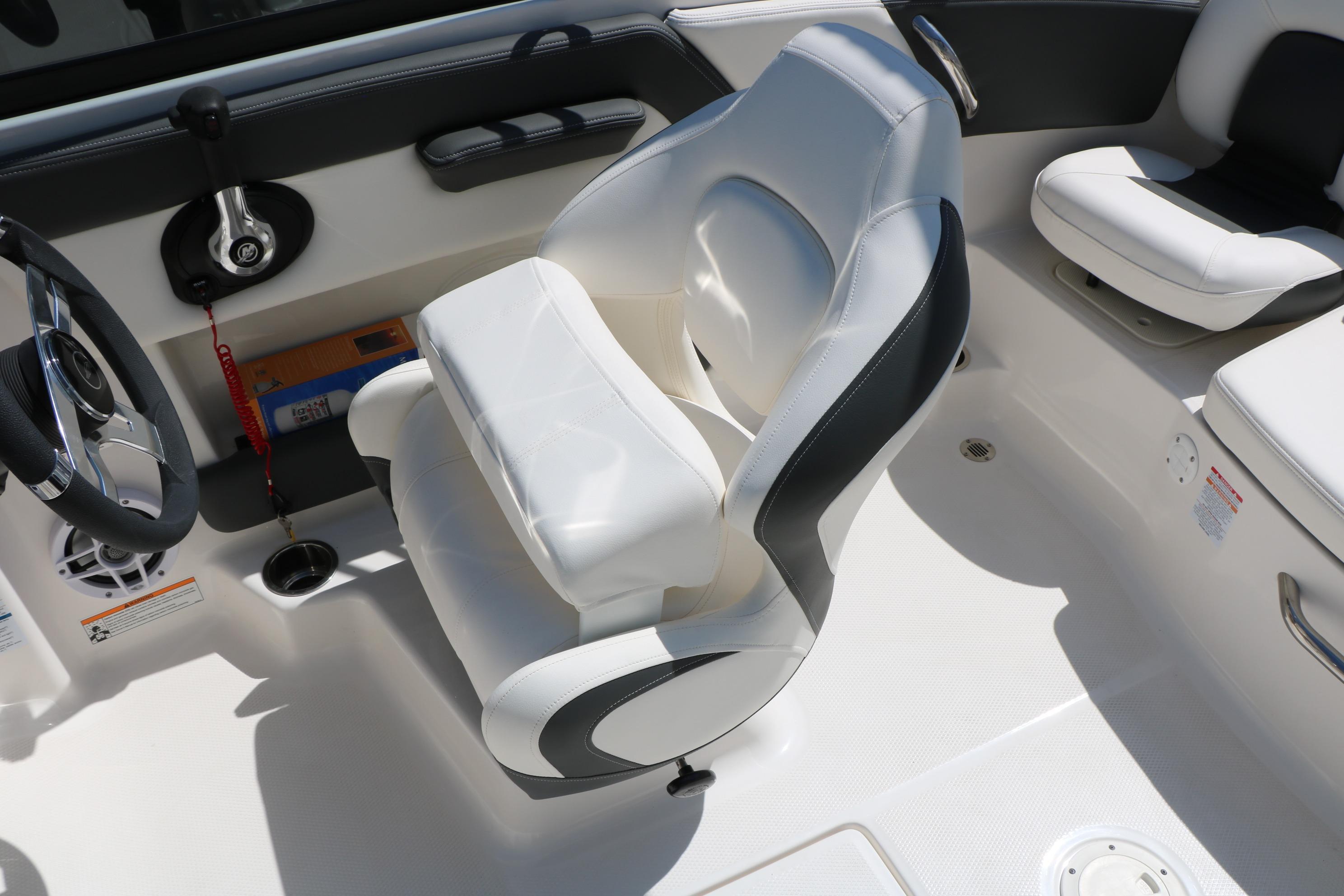 2025 Chaparral 21 SSi Ski & Fish boat interior with white seating and steering wheel.