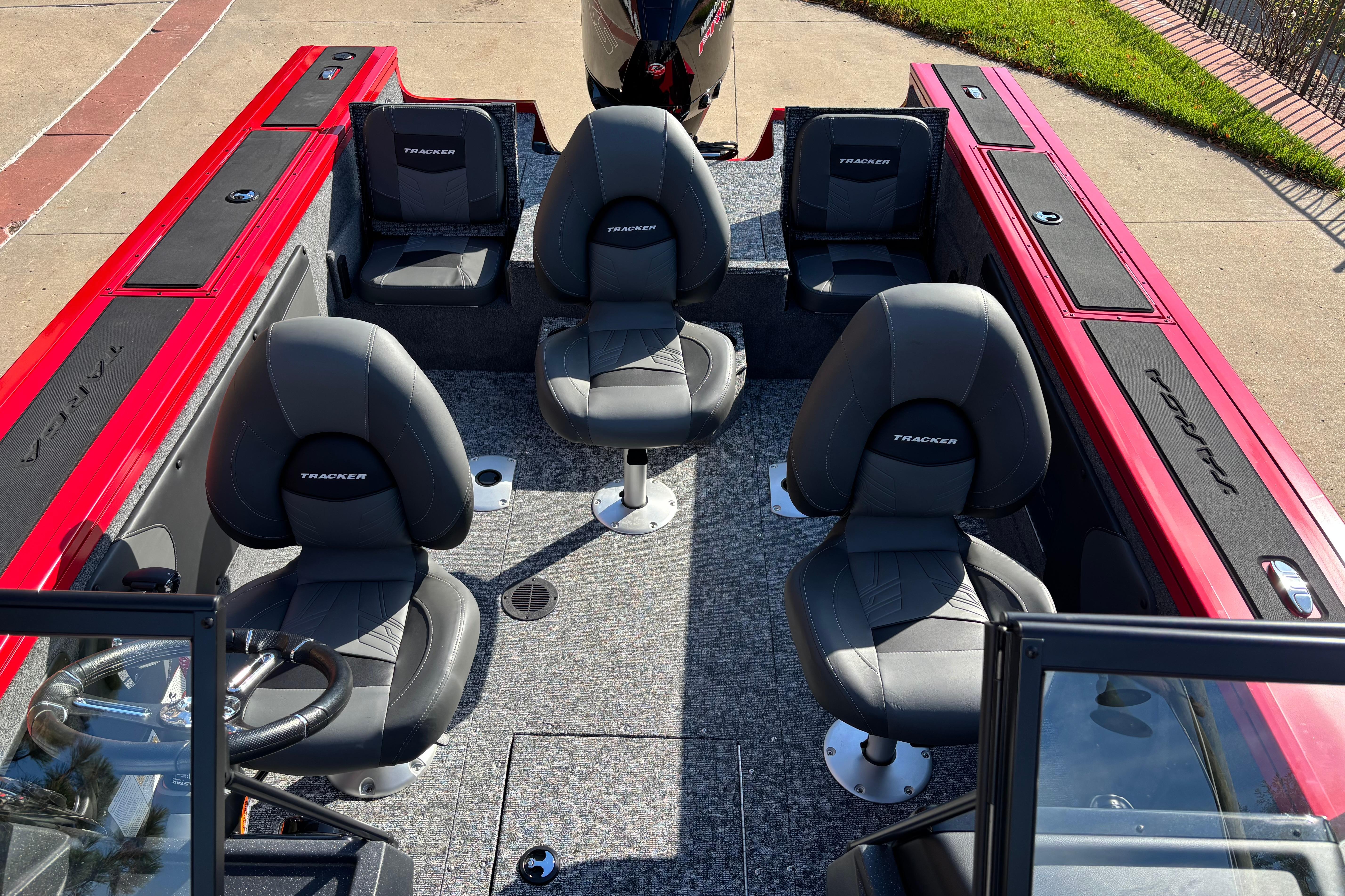 2026 Tracker Targa V-19 Combo boat interior with four seats, red accents, and steering wheel.