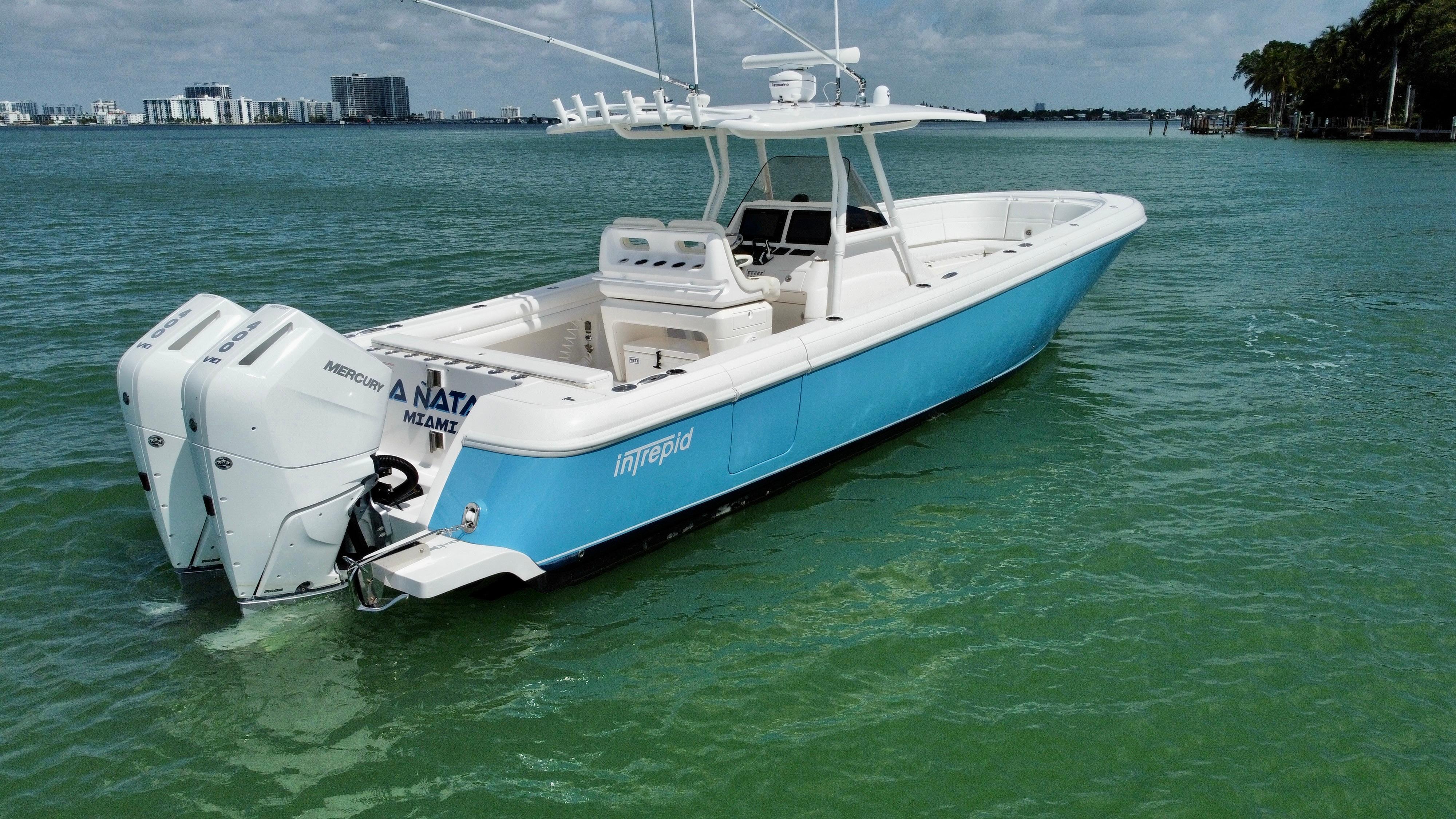 2015 Intrepid 375 Center Console boat on calm water, featuring twin outboard engines.