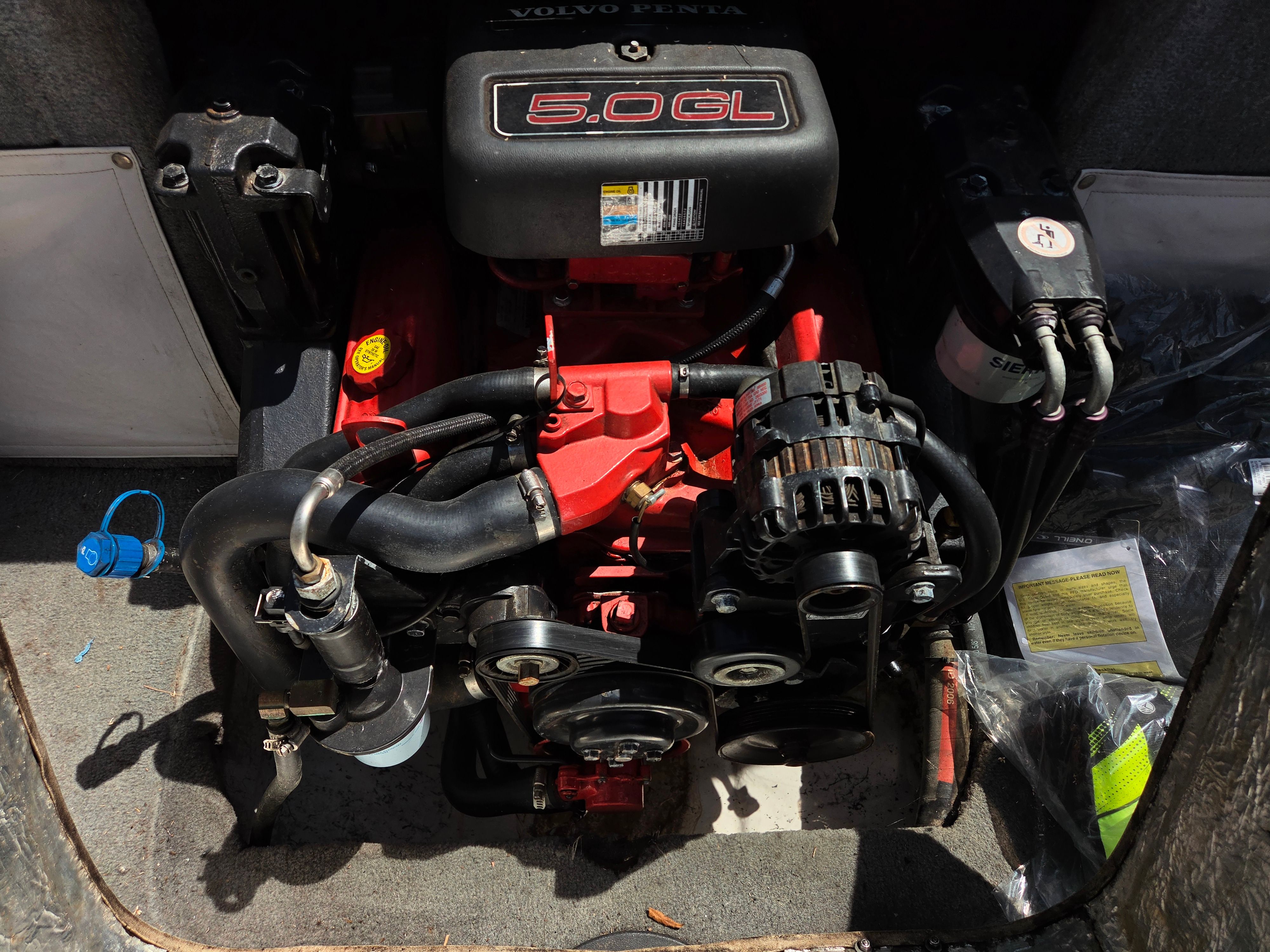 Engine compartment of a boat with a Volvo Penta 5.0 GL engine.