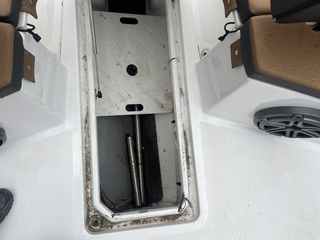 2022 Scarab 255 Open ID boat storage compartment with open hatch.