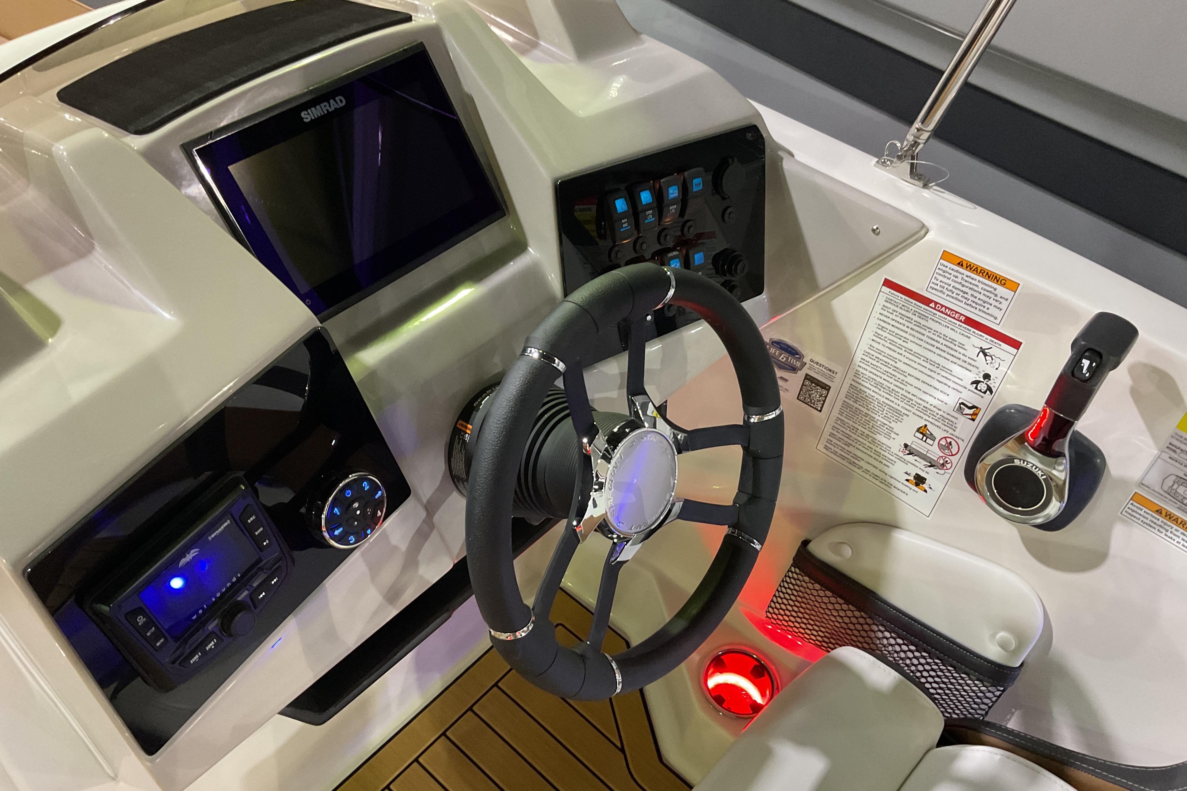 2026 Starcraft SVX 211 OB boat dashboard with steering wheel and control panel.