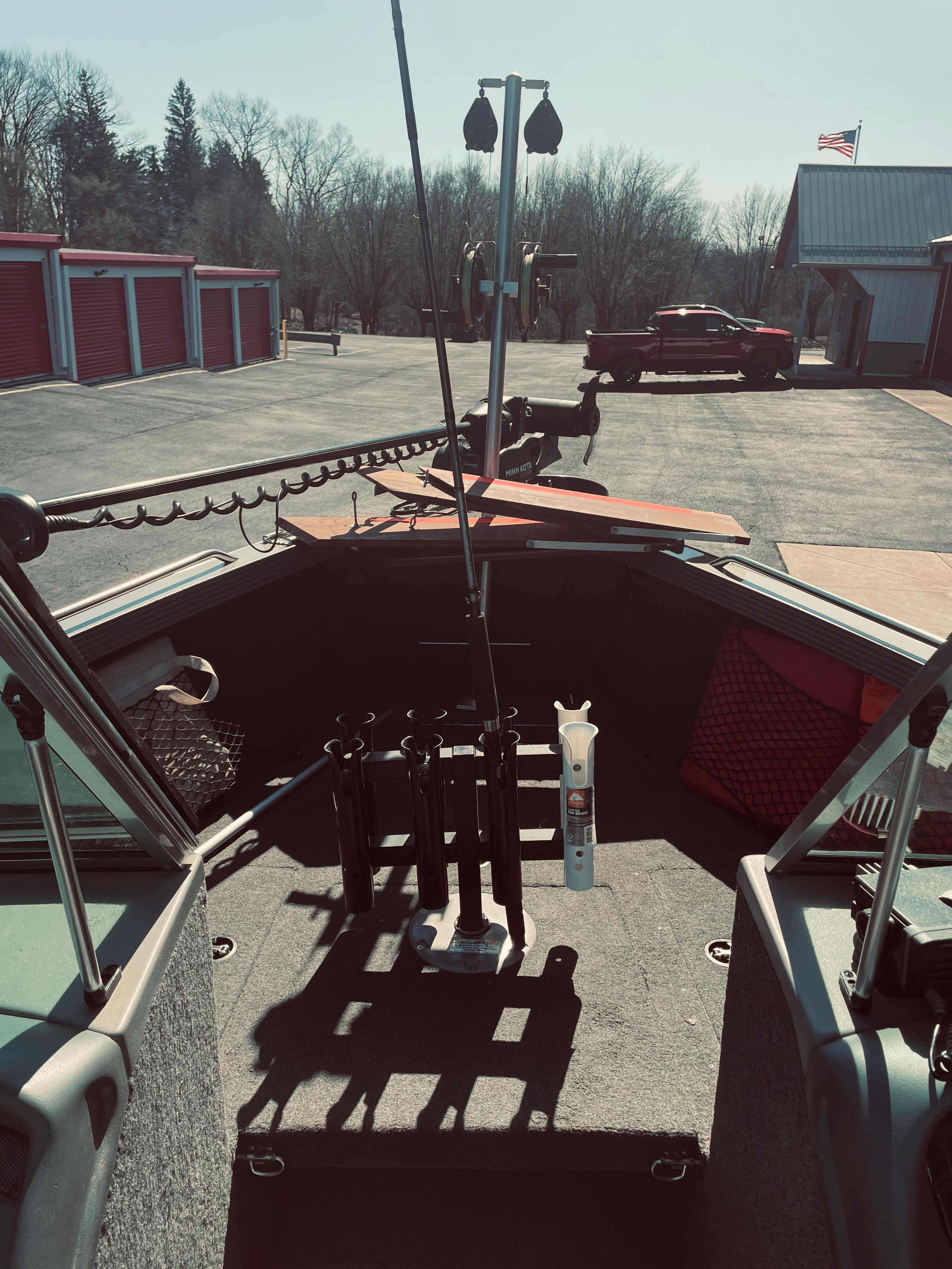 The image shows the interior of a 2012 Lund Baron boat parked in a lot.
