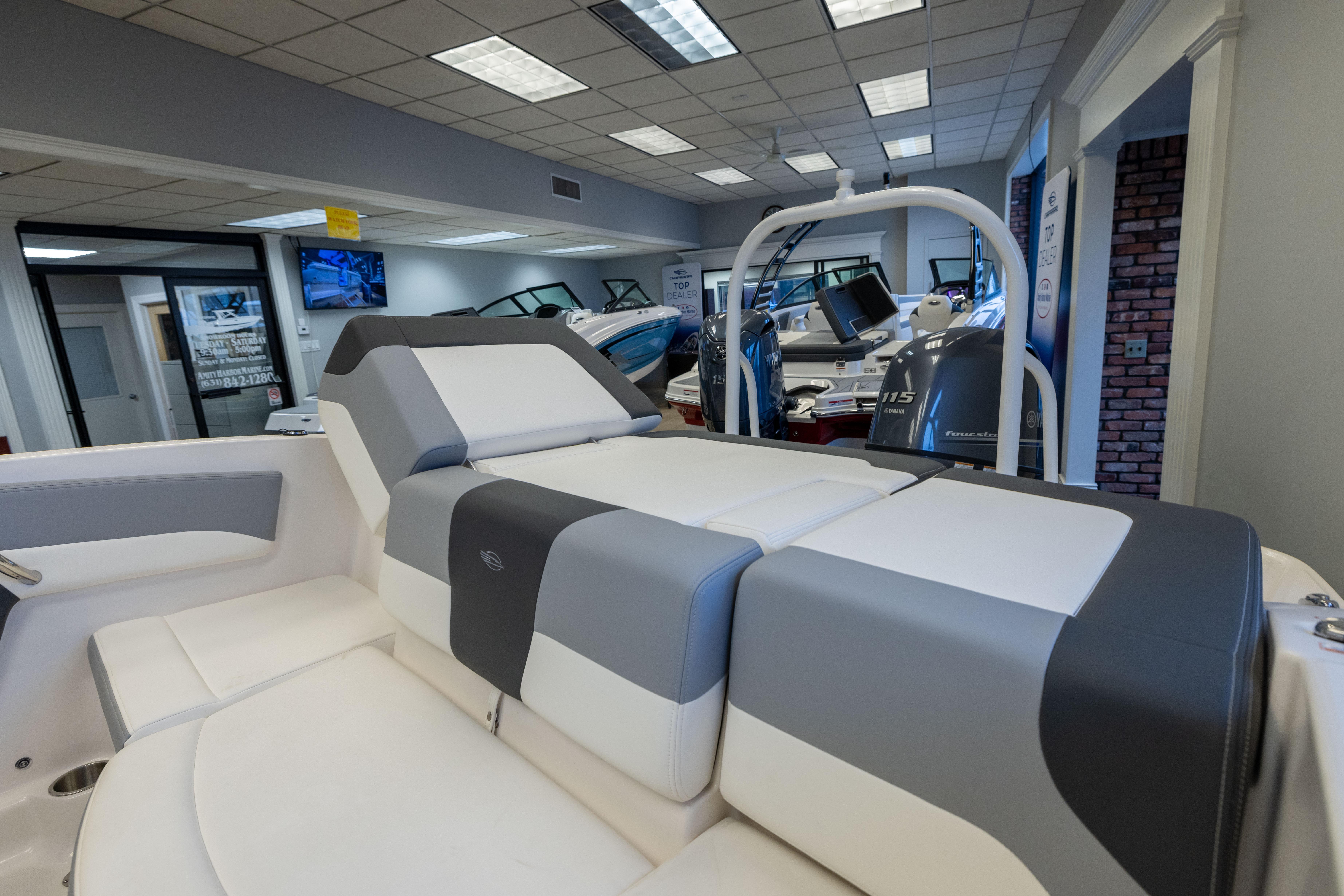 2024 Chaparral 19 SSi OB boat interior with sleek seating in showroom.