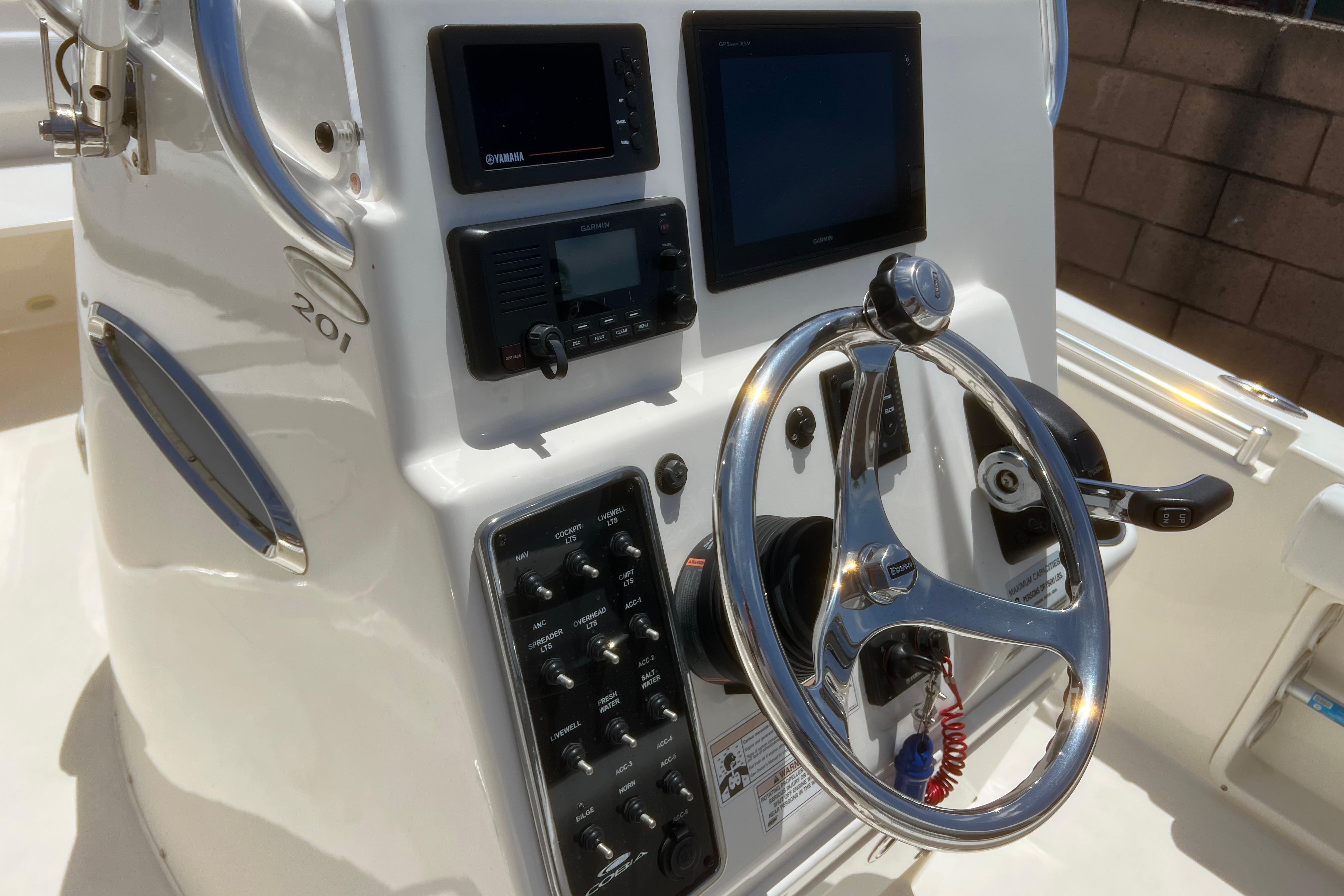2018 Cobia 201 Center Console boat dashboard with steering wheel and navigation controls.
