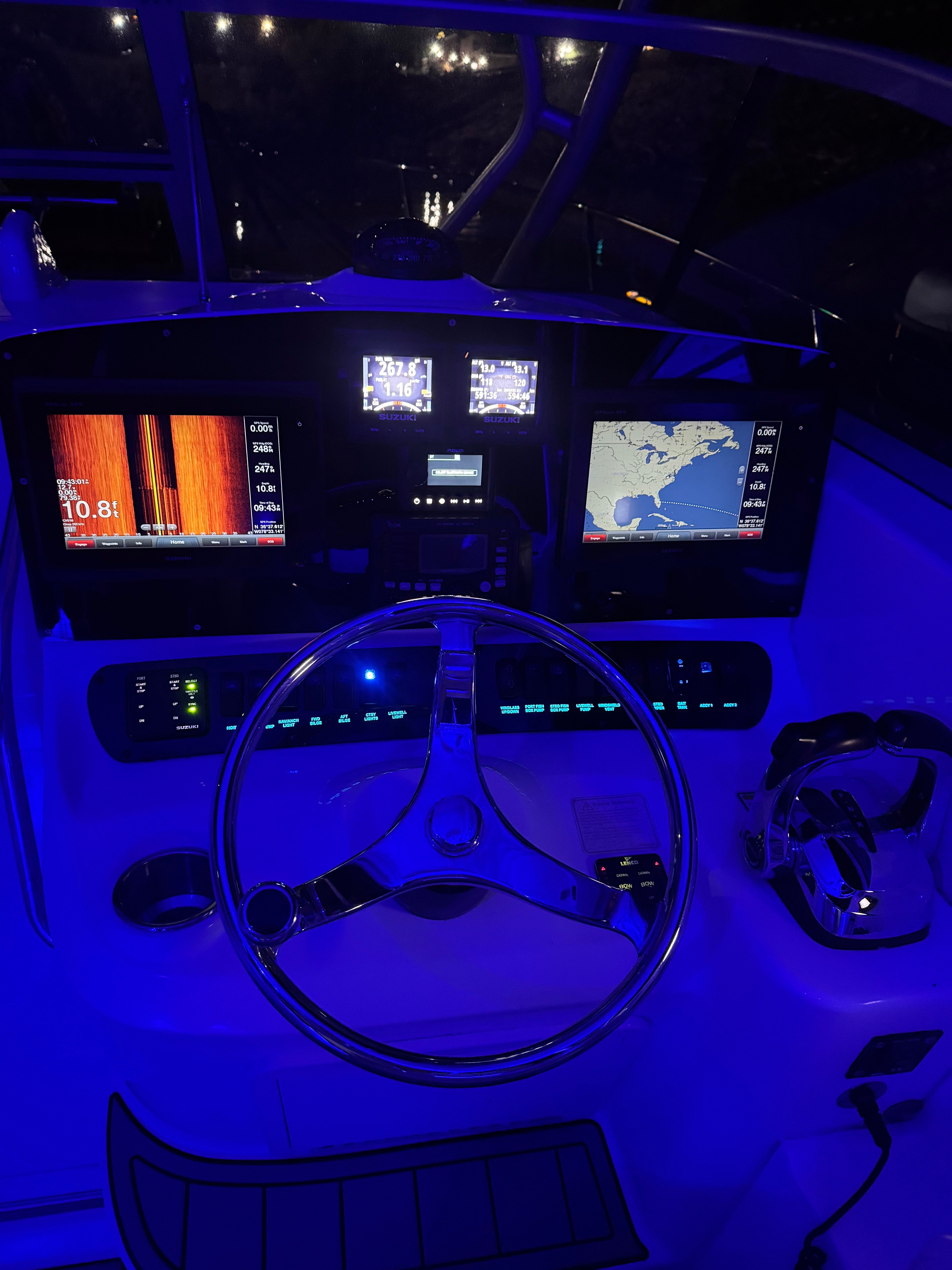 The cockpit of a 2006 Boston Whaler 305 Conquest with illuminated instruments and controls.