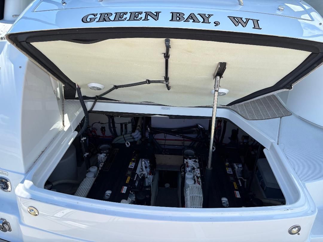 Engine compartment of a 2011 Formula 45 boat with two engines, open hatch, labeled "Green Bay, WI."