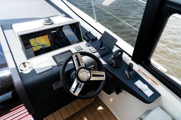 Helm of 2022 Bavaria SR41 yacht with navigation screens and controls.