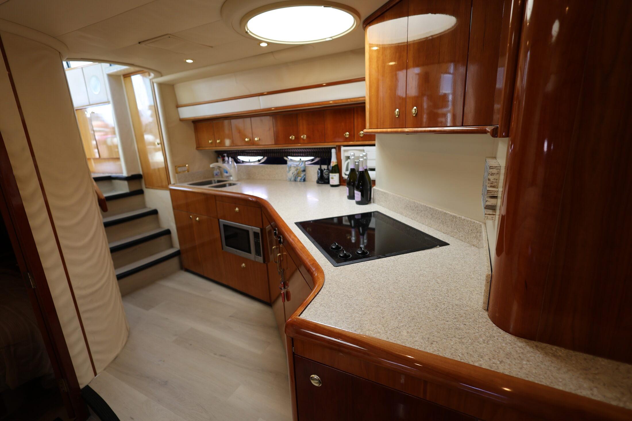Luxurious kitchen interior of 1999 Neptunus 54 Express yacht with modern amenities.
