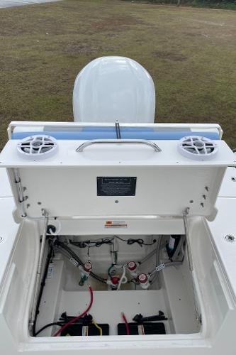2026 Robalo 246 Cayman boat with open storage compartment and visible wiring.