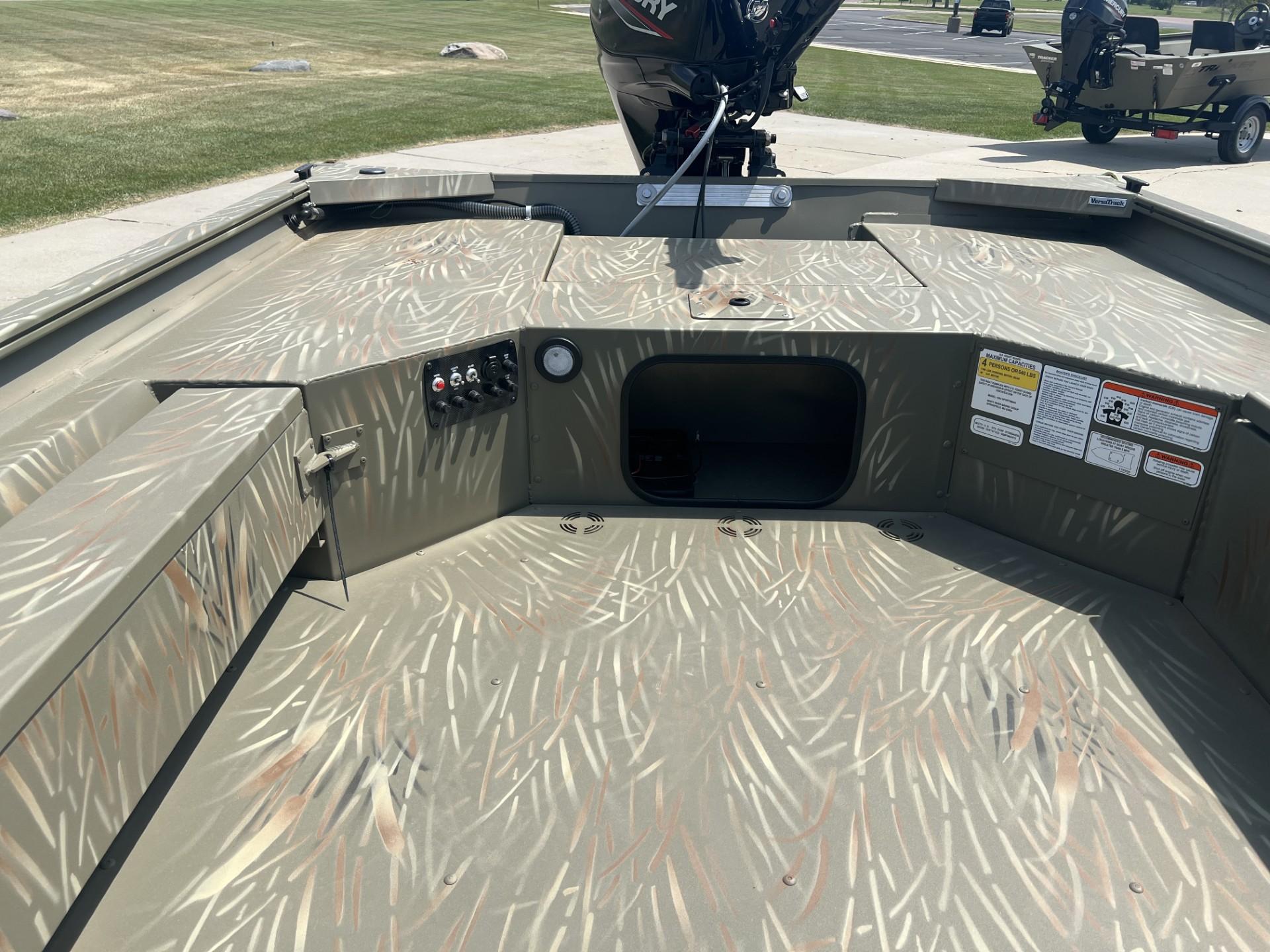 2025 Tracker Grizzly 1654 T Sportsman boat interior with camouflage pattern and control panel.