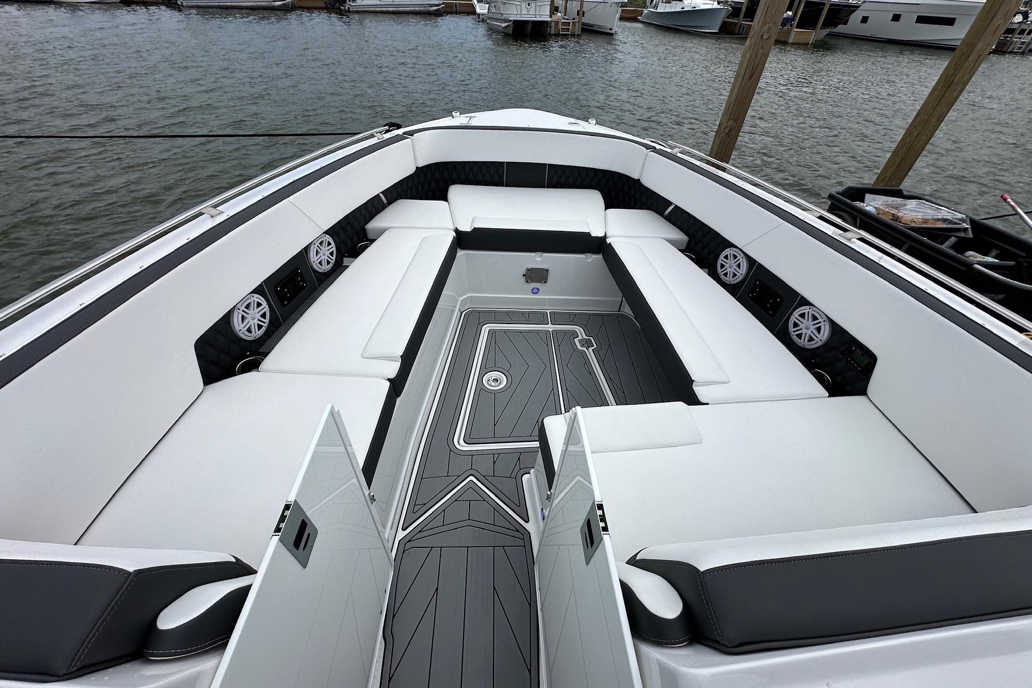 Luxurious seating area on a 2023 Monterey 378SS Super Sport boat, docked by the water.