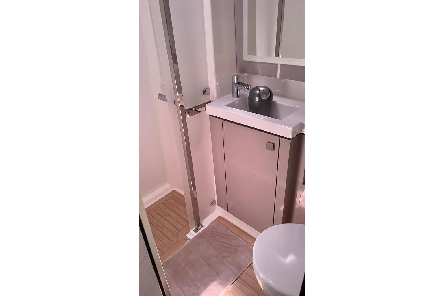 Modern bathroom in 2020 Fountaine Pajot Saona 47 yacht with sleek fixtures and compact design.