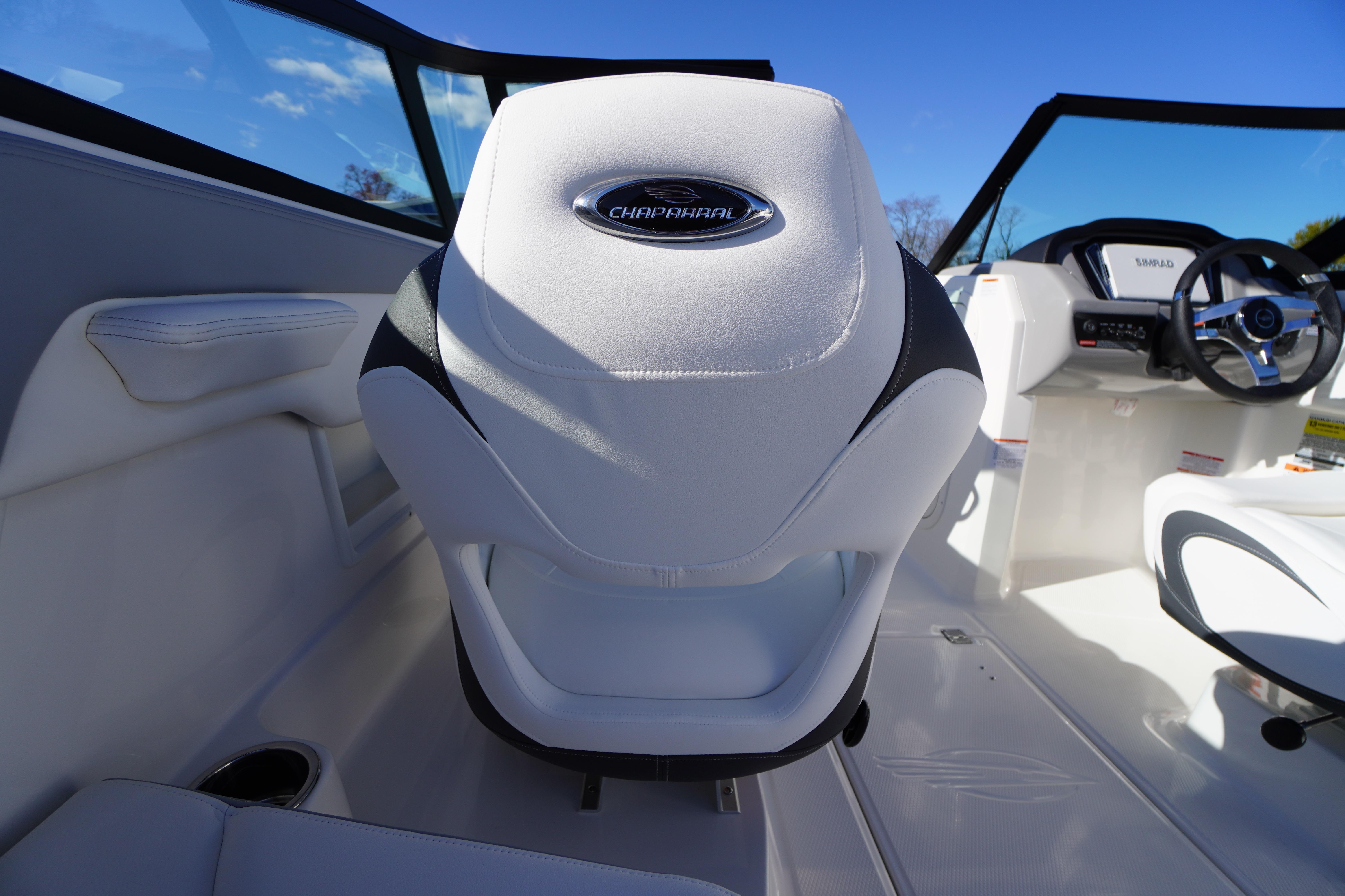 2026 Chaparral 23 SSi boat interior with white seating and steering wheel.