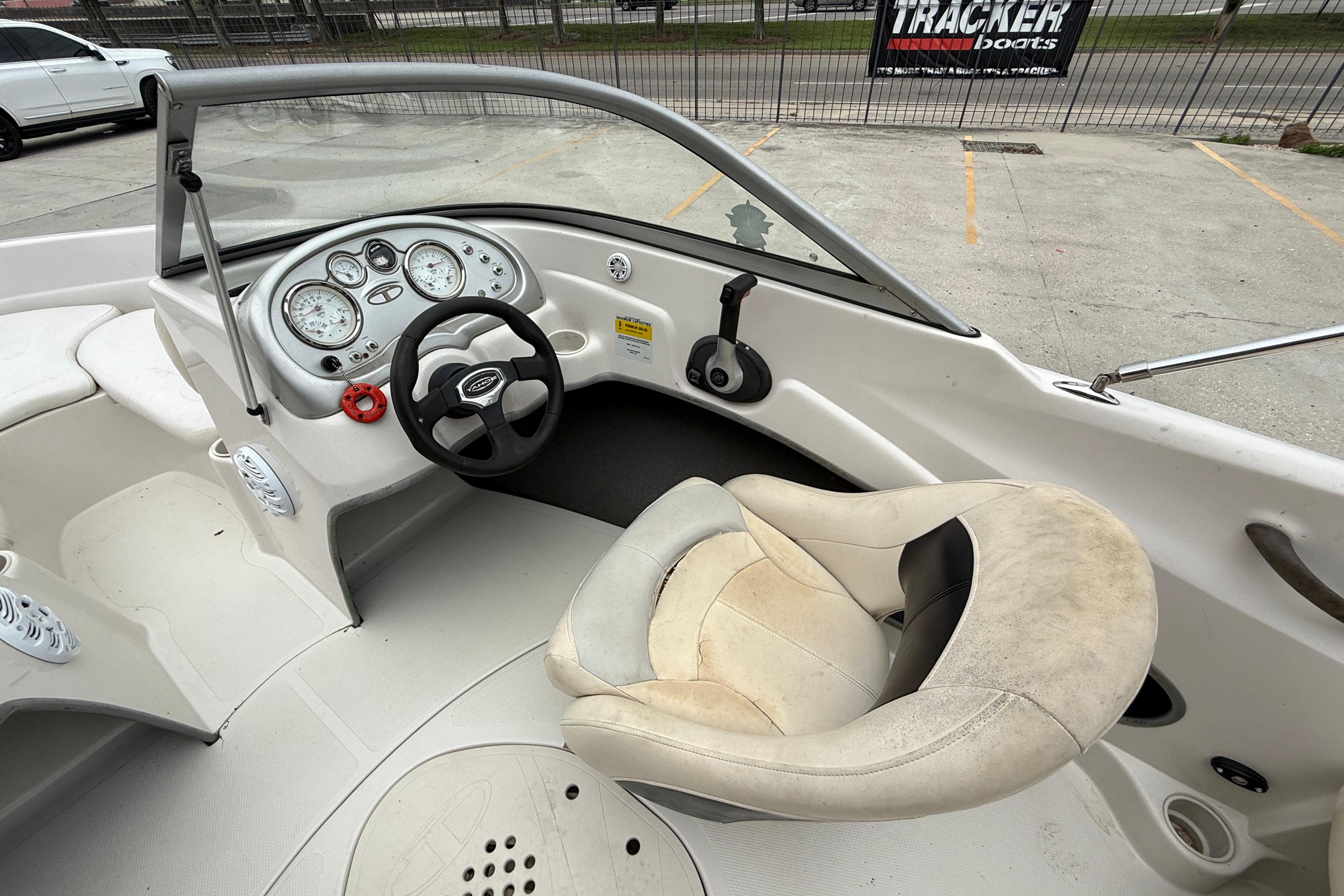 2010 Tahoe Q4 boat interior with steering wheel and dashboard controls.