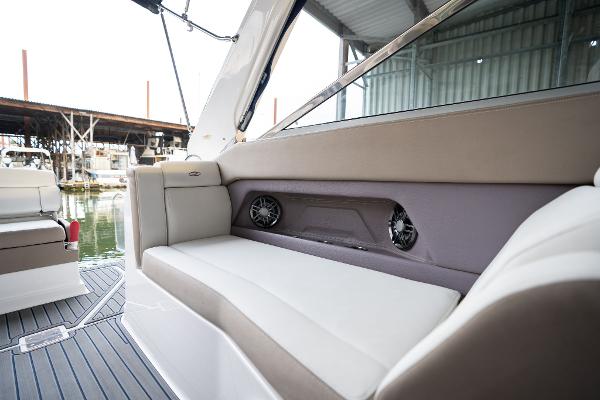2016 Regal 28 Express boat interior with cushioned seating and built-in speakers.
