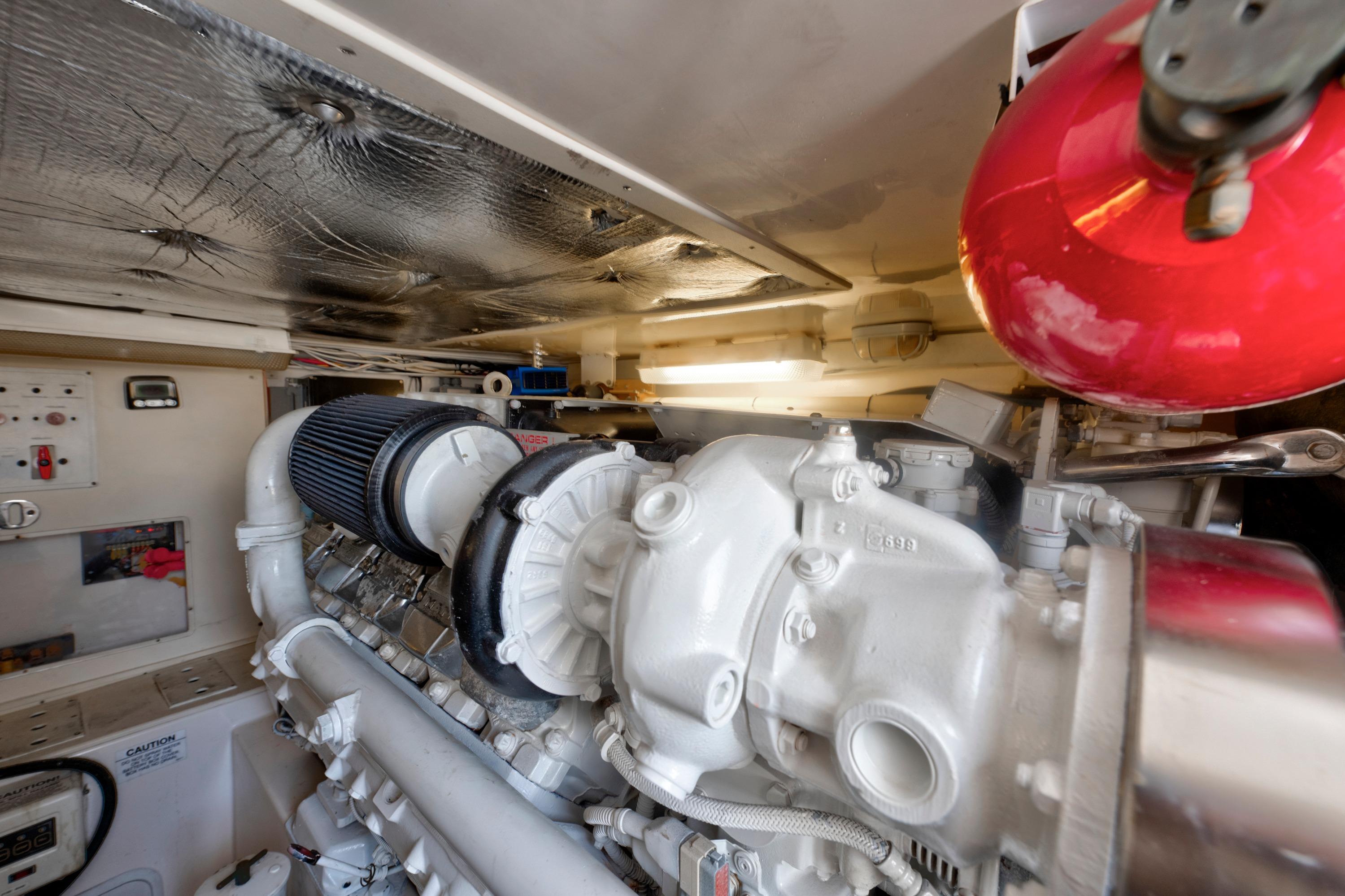Engine room of 2010 Cabo 45 Express boat, featuring a powerful marine engine.