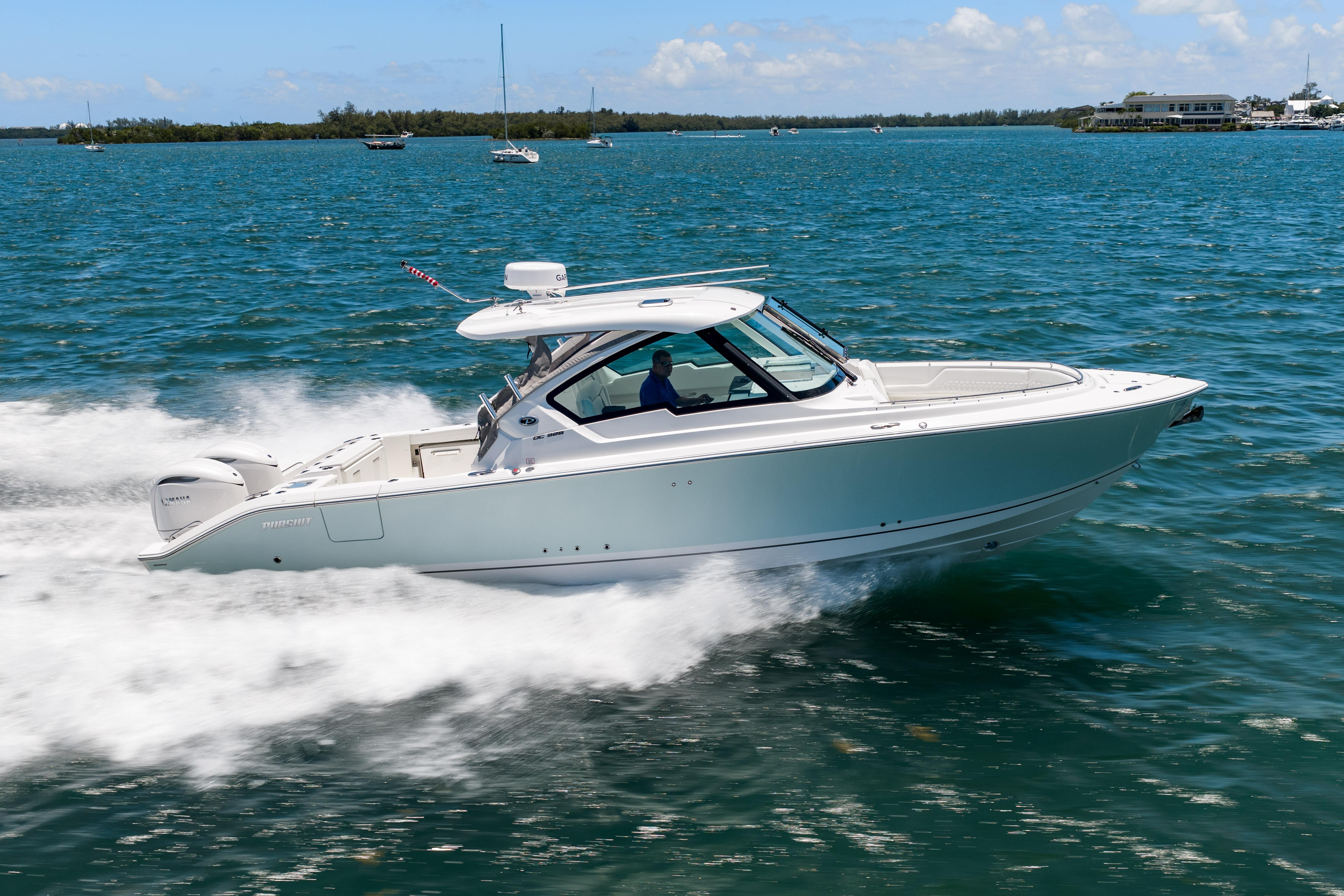 2026 Pursuit DC 326 Dual Console boat cruising on clear blue water.