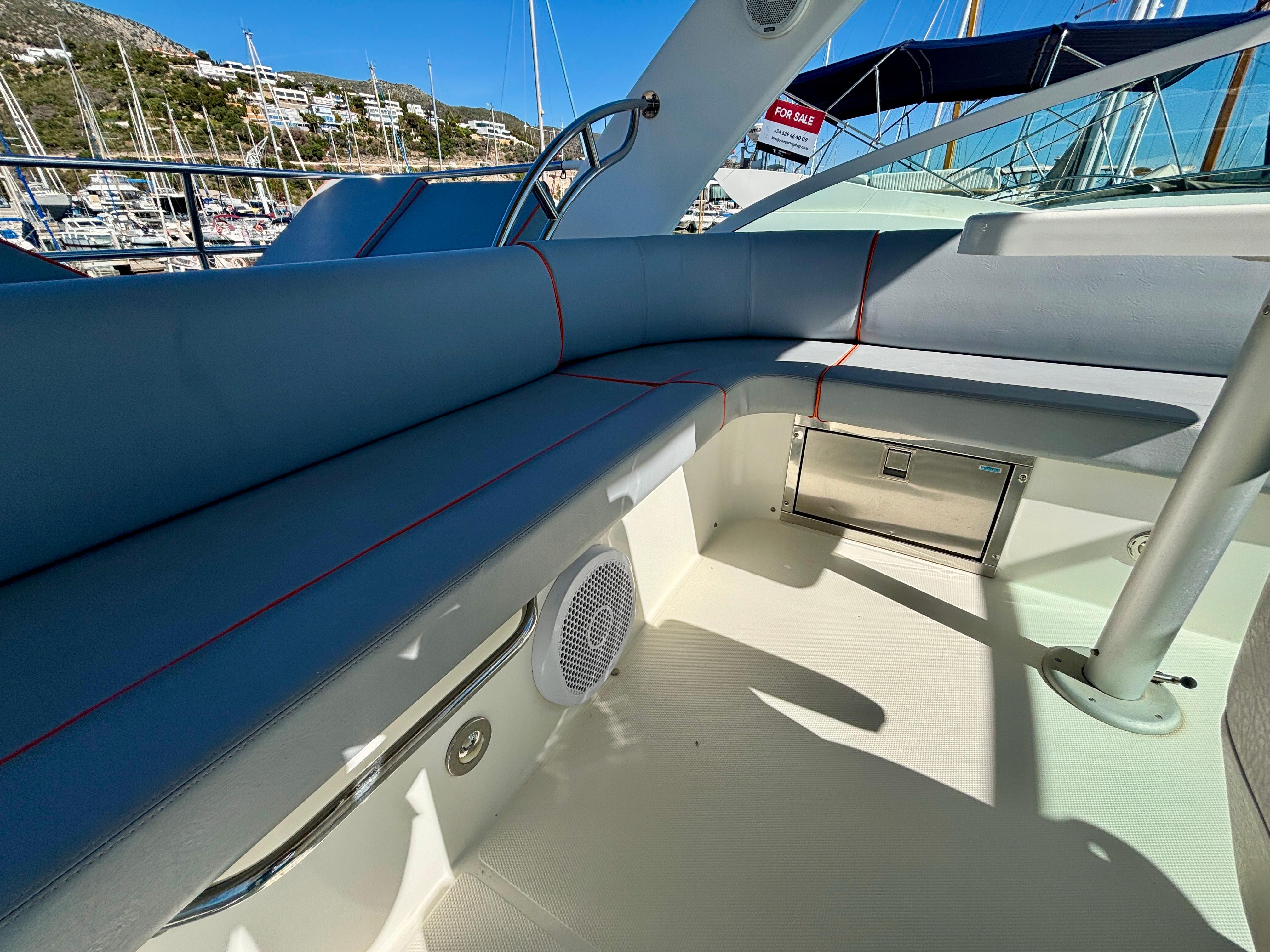 2007 Cruisers Yachts 447 Sport Sedan interior with blue seating and marina view.