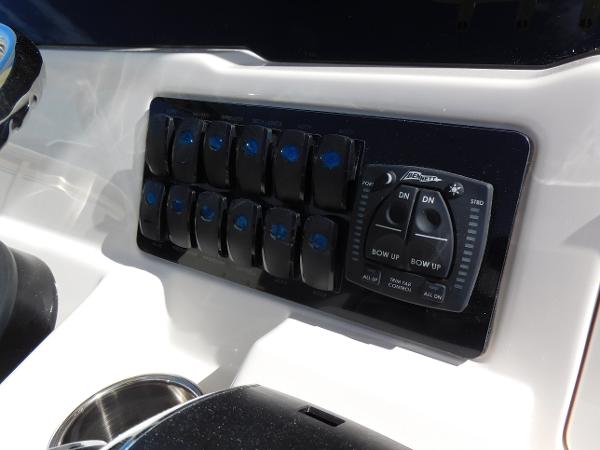 Control panel of 2024 Sailfish 242 CC boat with switches and joystick.
