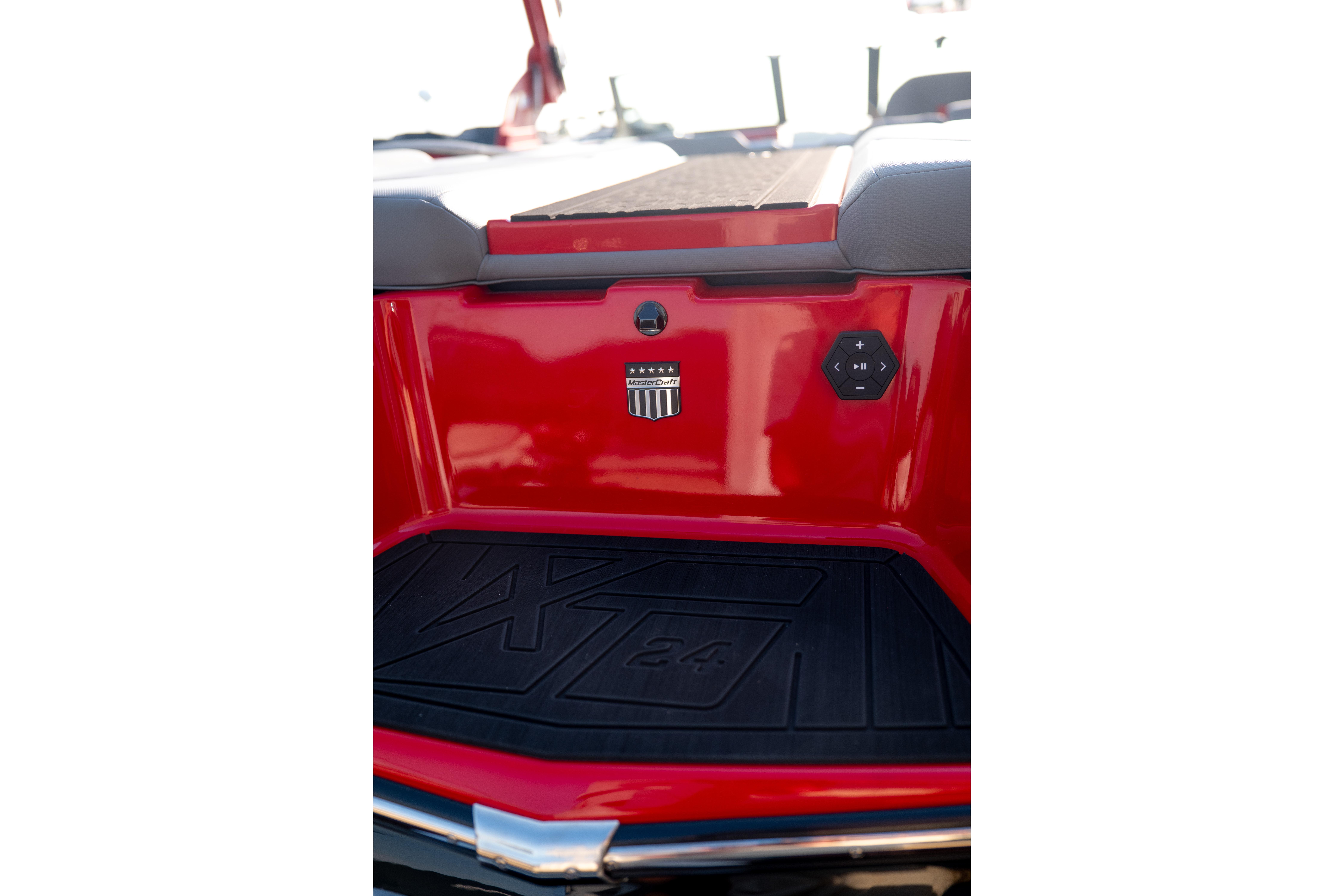 2027 MasterCraft XT24 boat rear view with red finish and control panel.