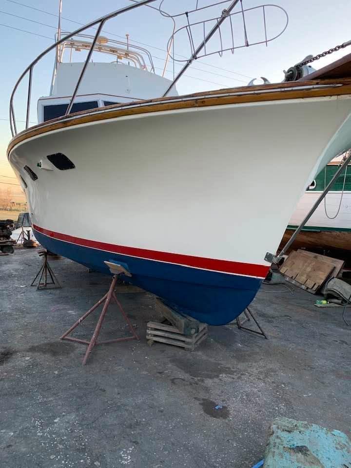 1976 Egg Harbor 33 Sportfisher on stands for maintenance.