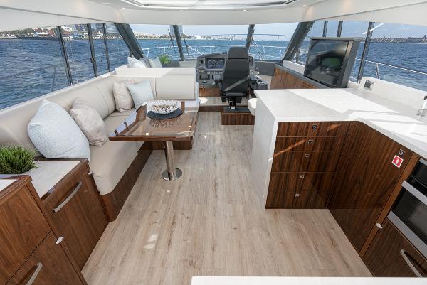 Luxurious interior of 2021 Riviera 5400 Sport Yacht with modern furnishings and panoramic views.