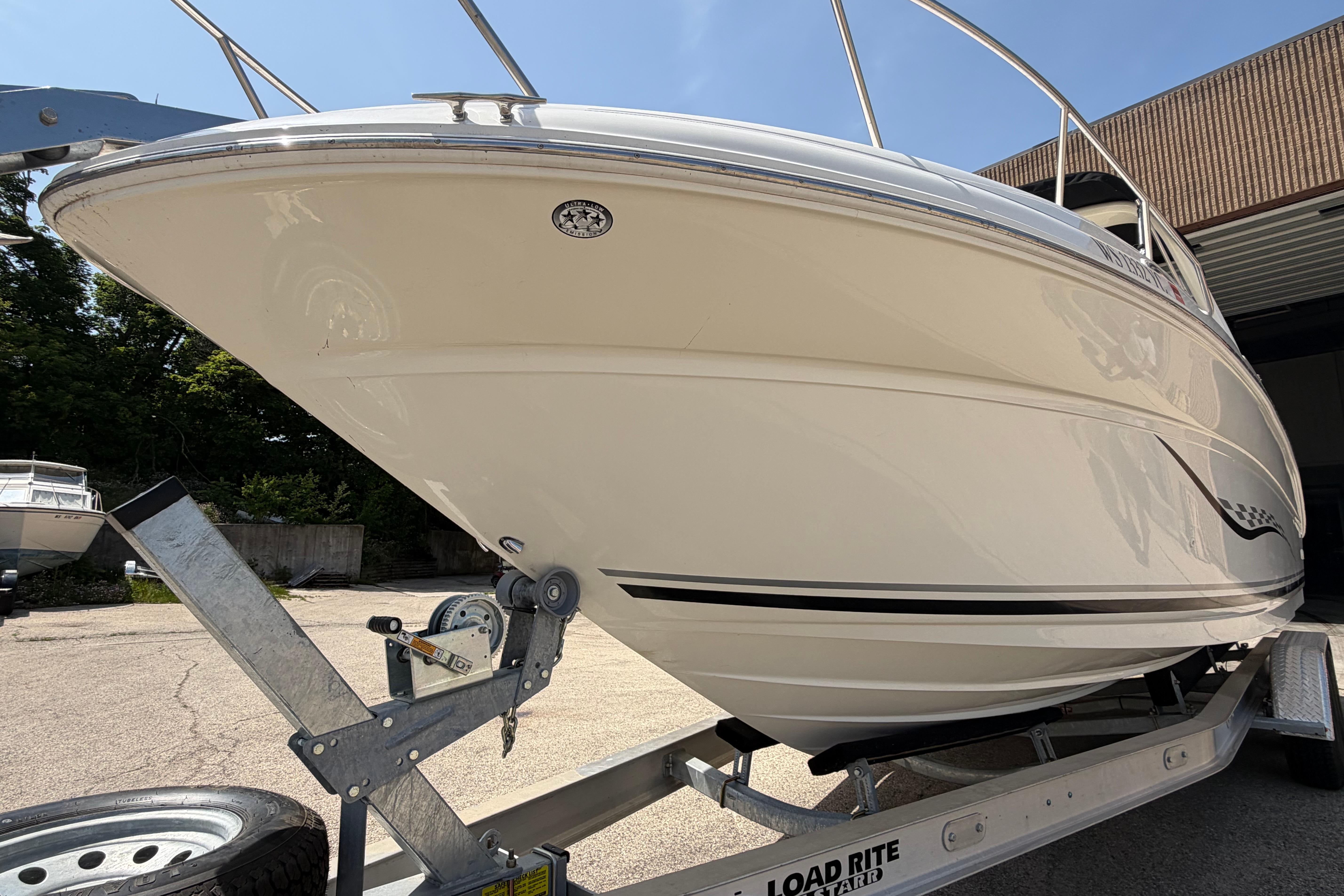 2004 Sea Ray Sundancer 260 on trailer, showcasing sleek design and polished hull.