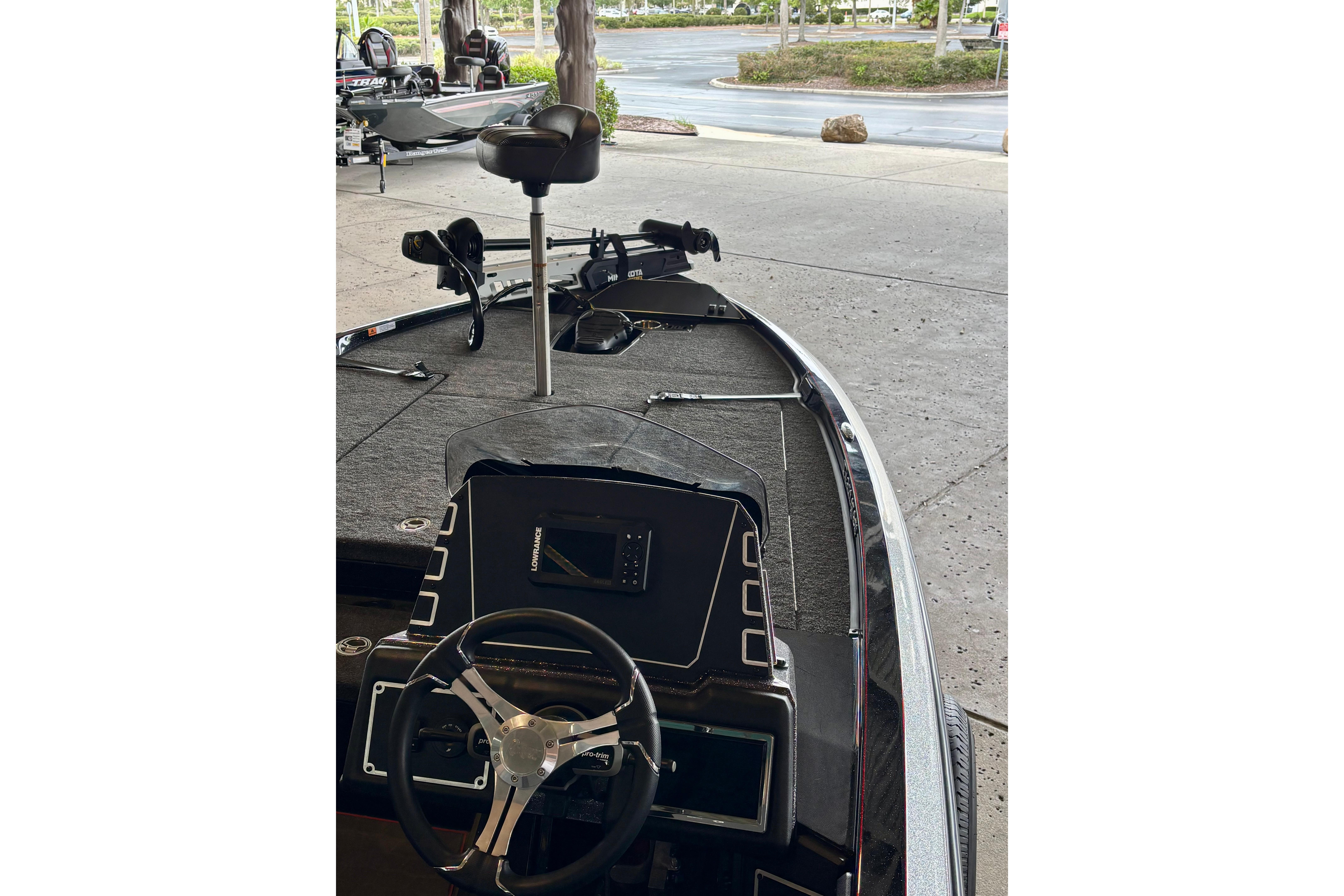 2025 Ranger Z519R boat interior with steering wheel and seating, parked outdoors.