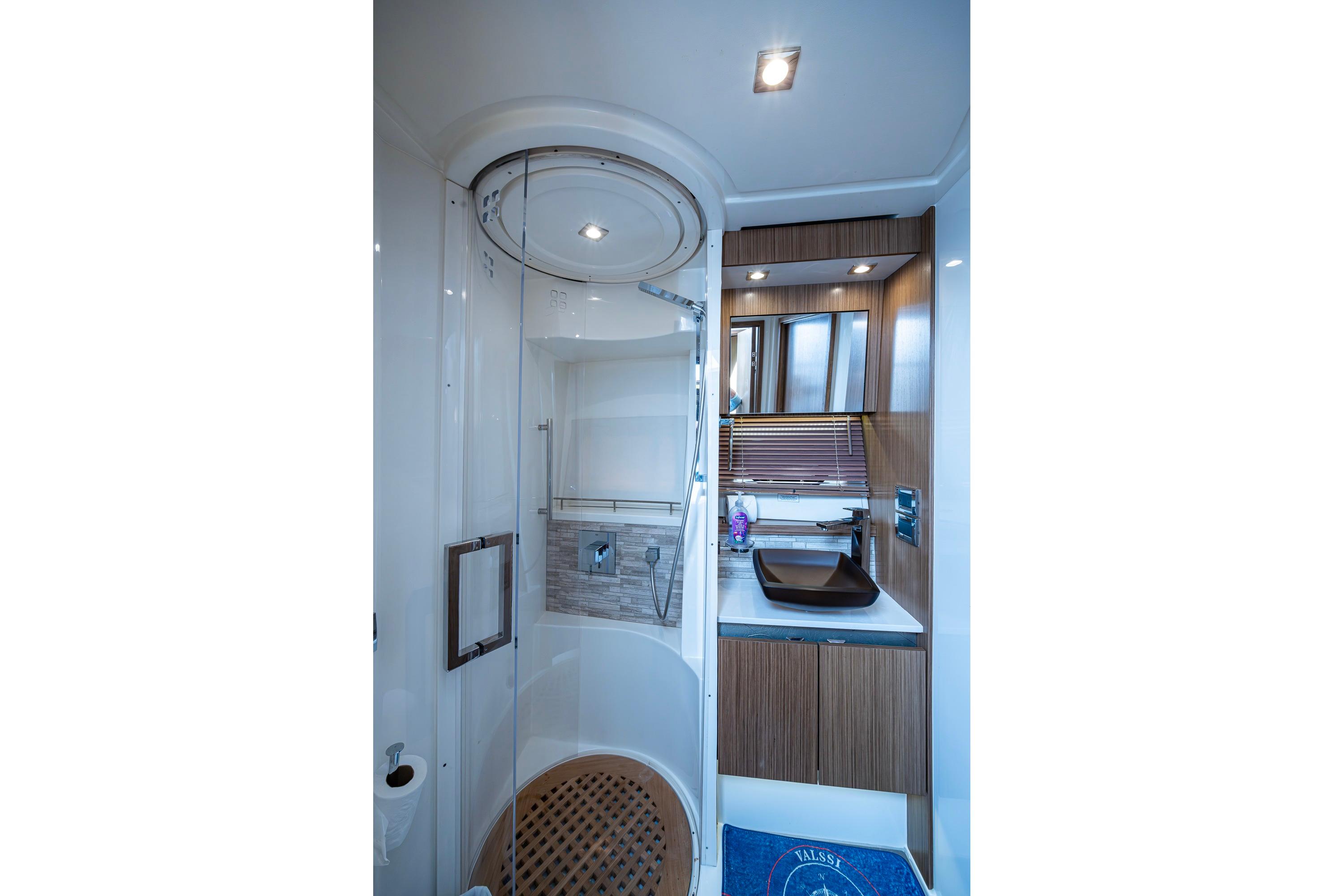 Luxurious bathroom in 2018 Sea Ray L550 Fly yacht with modern fixtures and elegant design.
