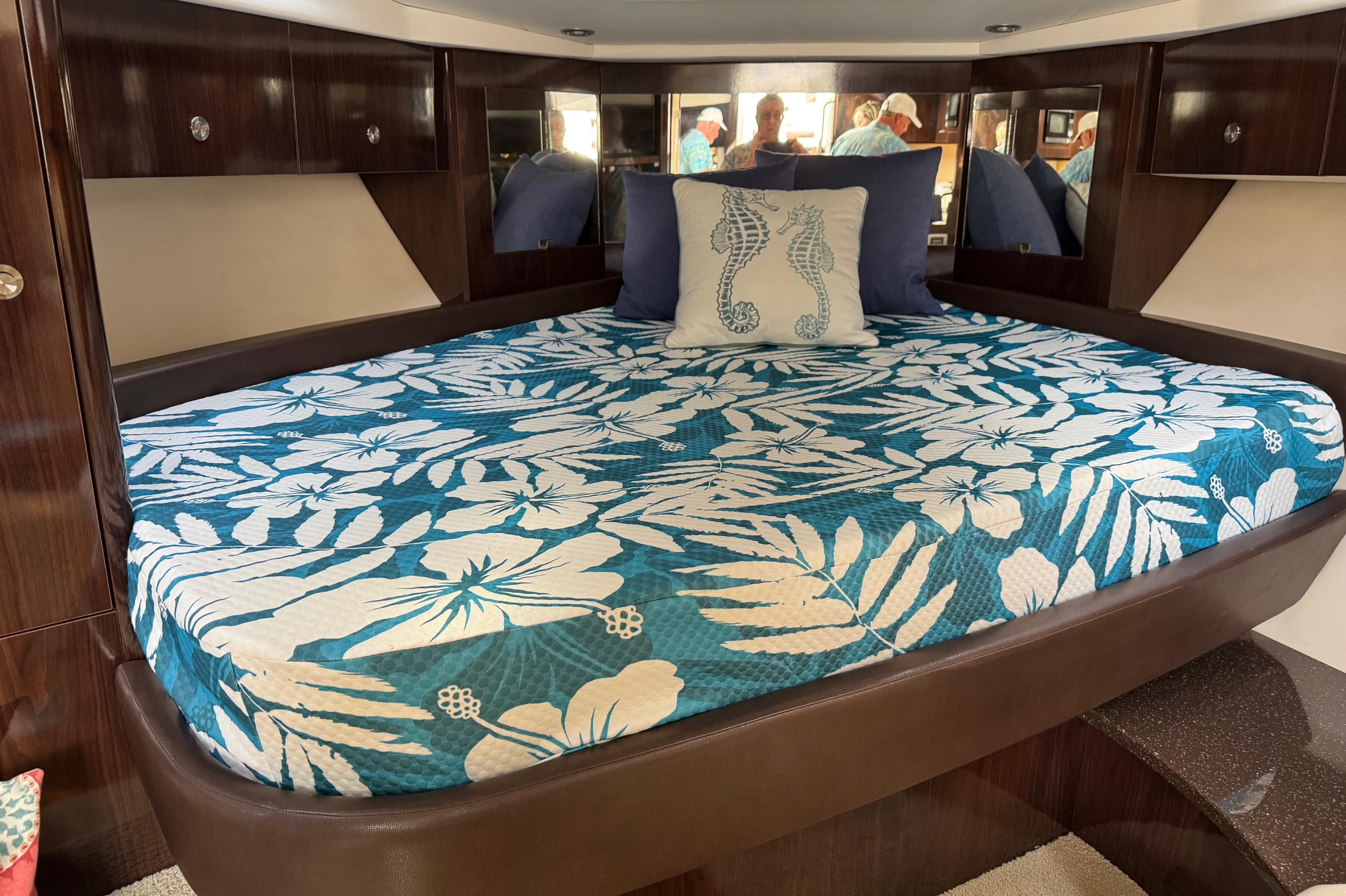 Luxurious cabin interior of 2016 Sea Ray Sundancer 350 with floral bedding.