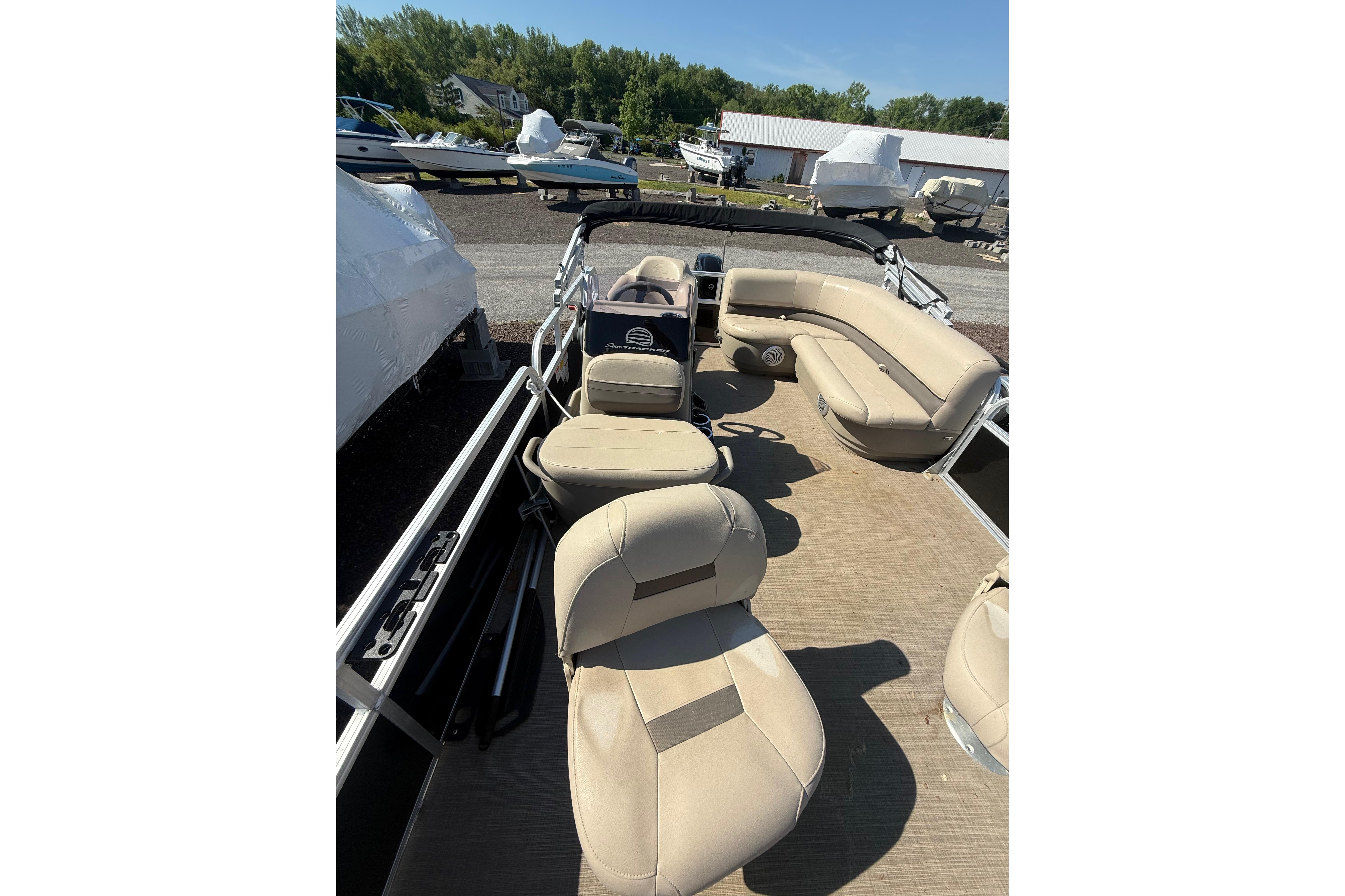 2021 Sun Tracker Bass Buggy 16 XL Select pontoon boat interior with beige seating.
