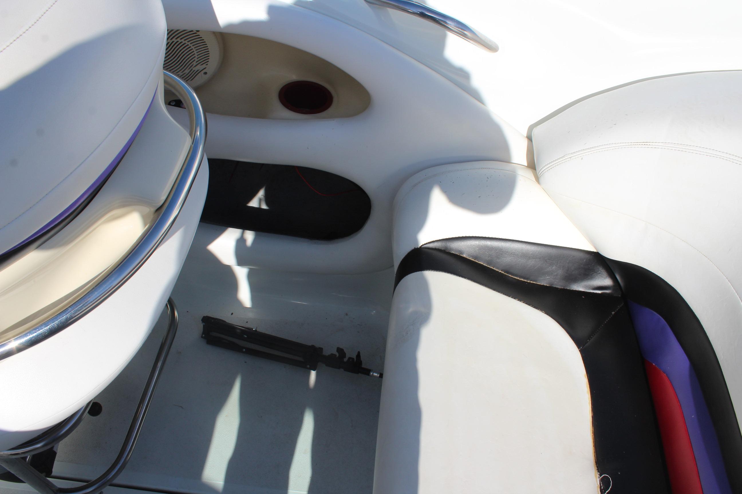 Interior of a 1996 Baja 232 boat showing white and black seating.