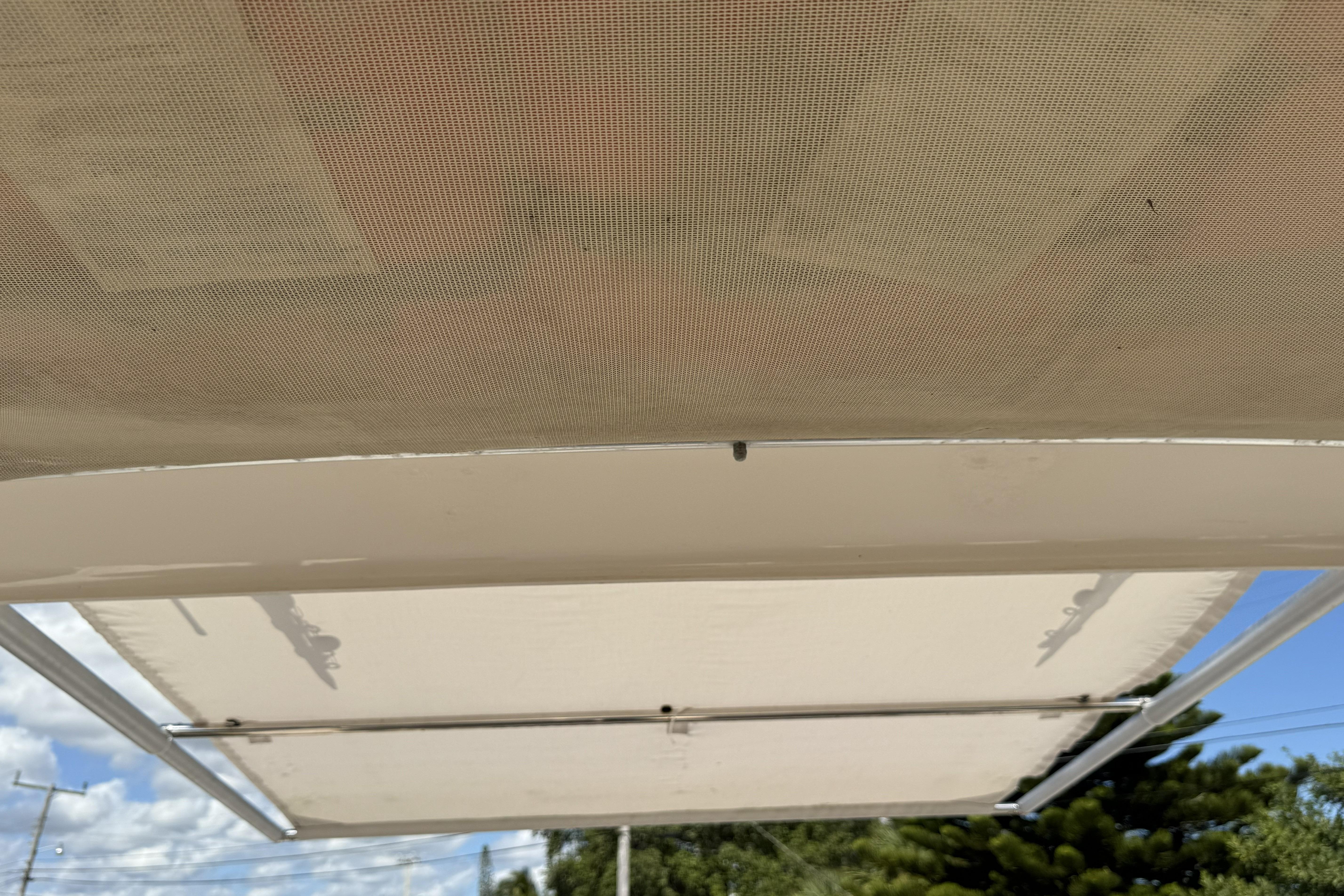 2014 Grady-White Freedom 275 boat canopy under clear blue sky.