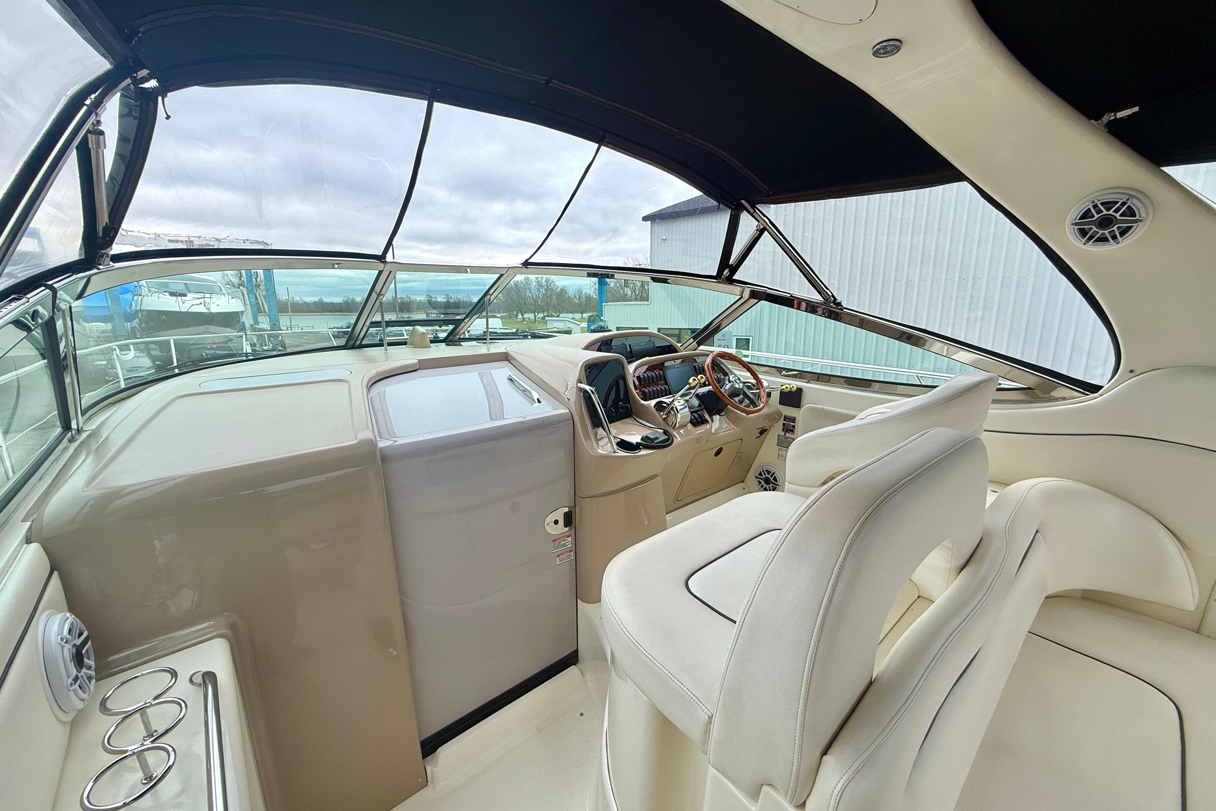 2004 Searay 360 Sundancer cockpit with beige interior and modern controls.