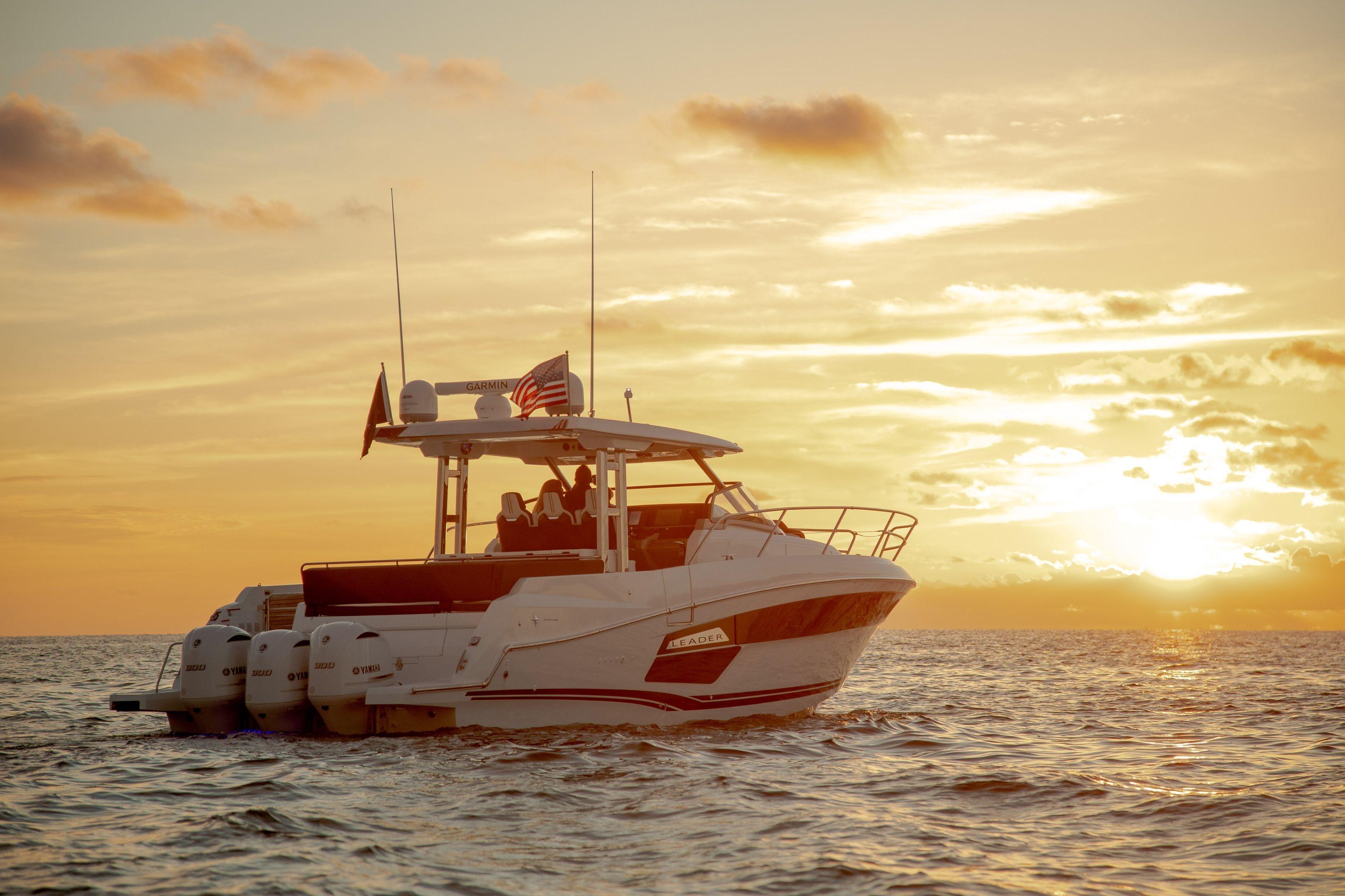 2026 Jeanneau Leader 12.5 WA boat cruising at sunset on open water.