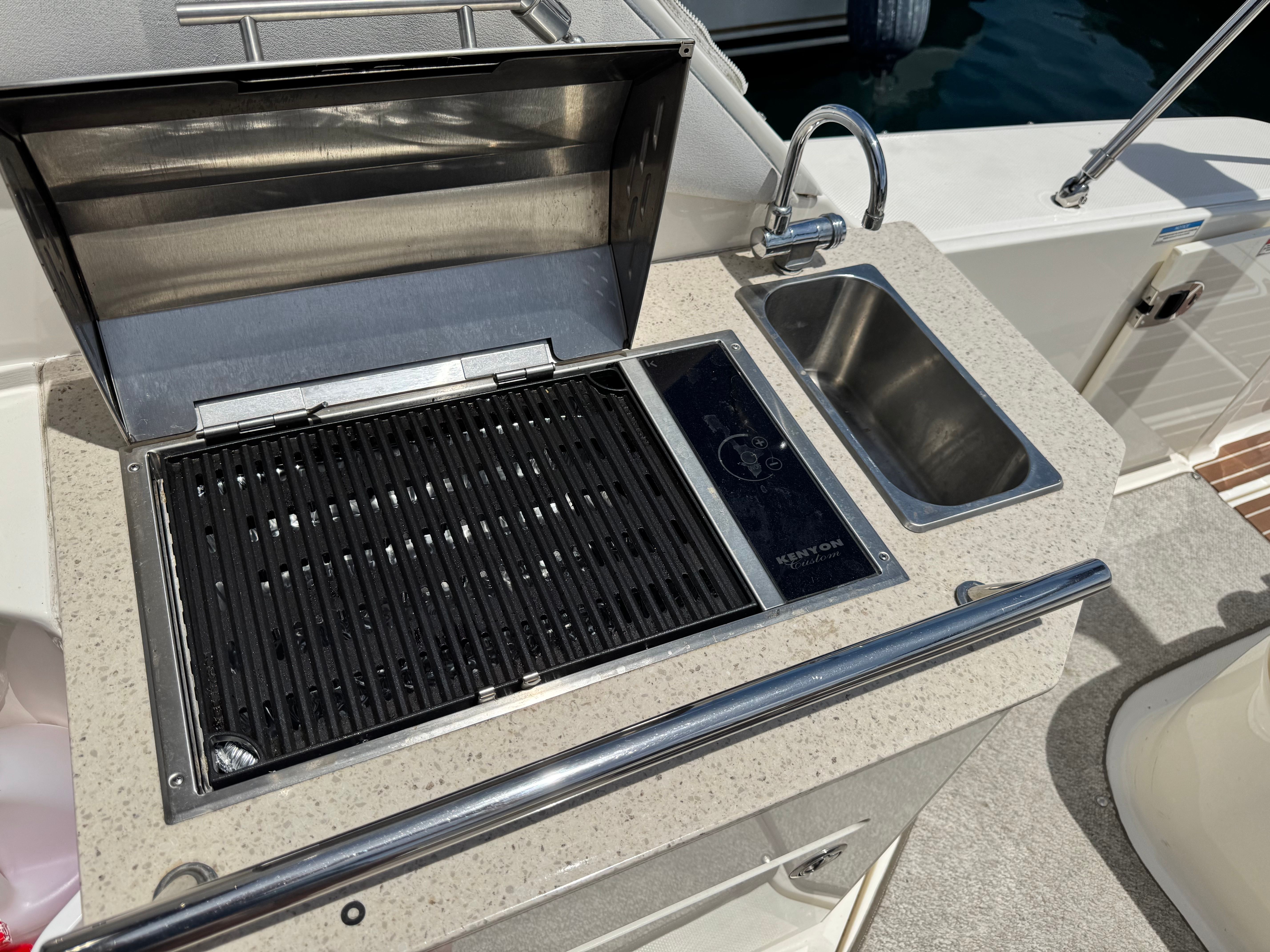 The 2010 Sea Ray Sundancer 310 features a built-in grill and sink.