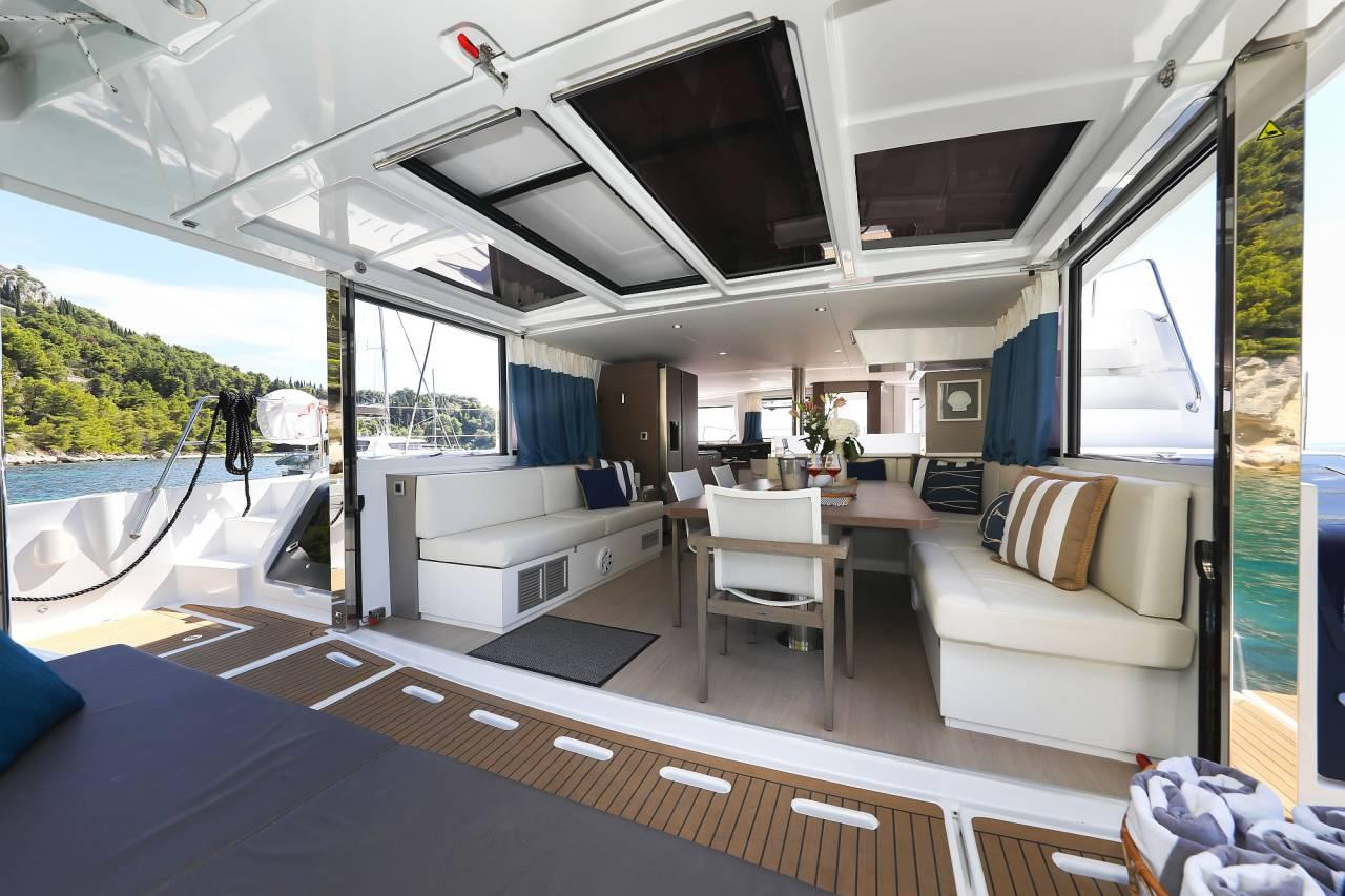 Luxurious Bali 4.8 yacht interior with spacious seating, dining area, and scenic ocean view.