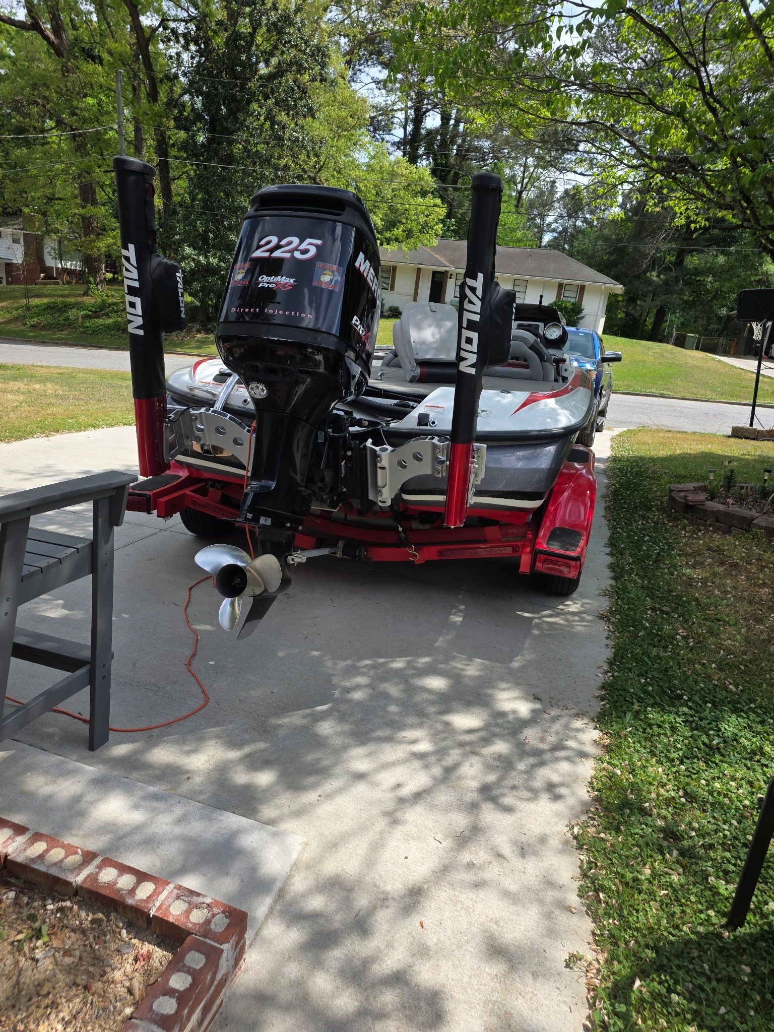 A 2010 Nitro Z-8 boat on a trailer in a driveway.