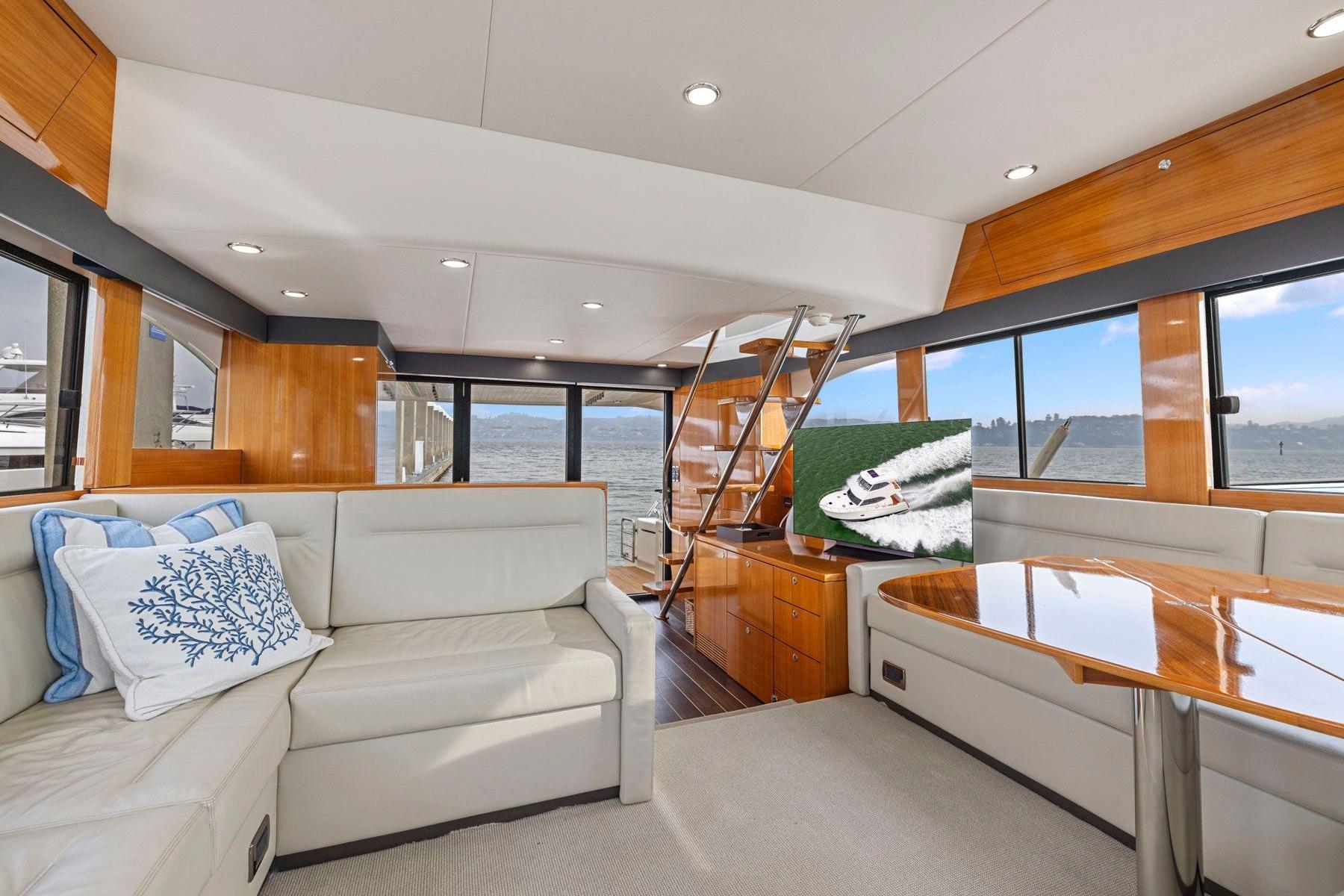 Luxurious interior of 2014 Maritimo M50 yacht with elegant wood finishes and comfortable seating.