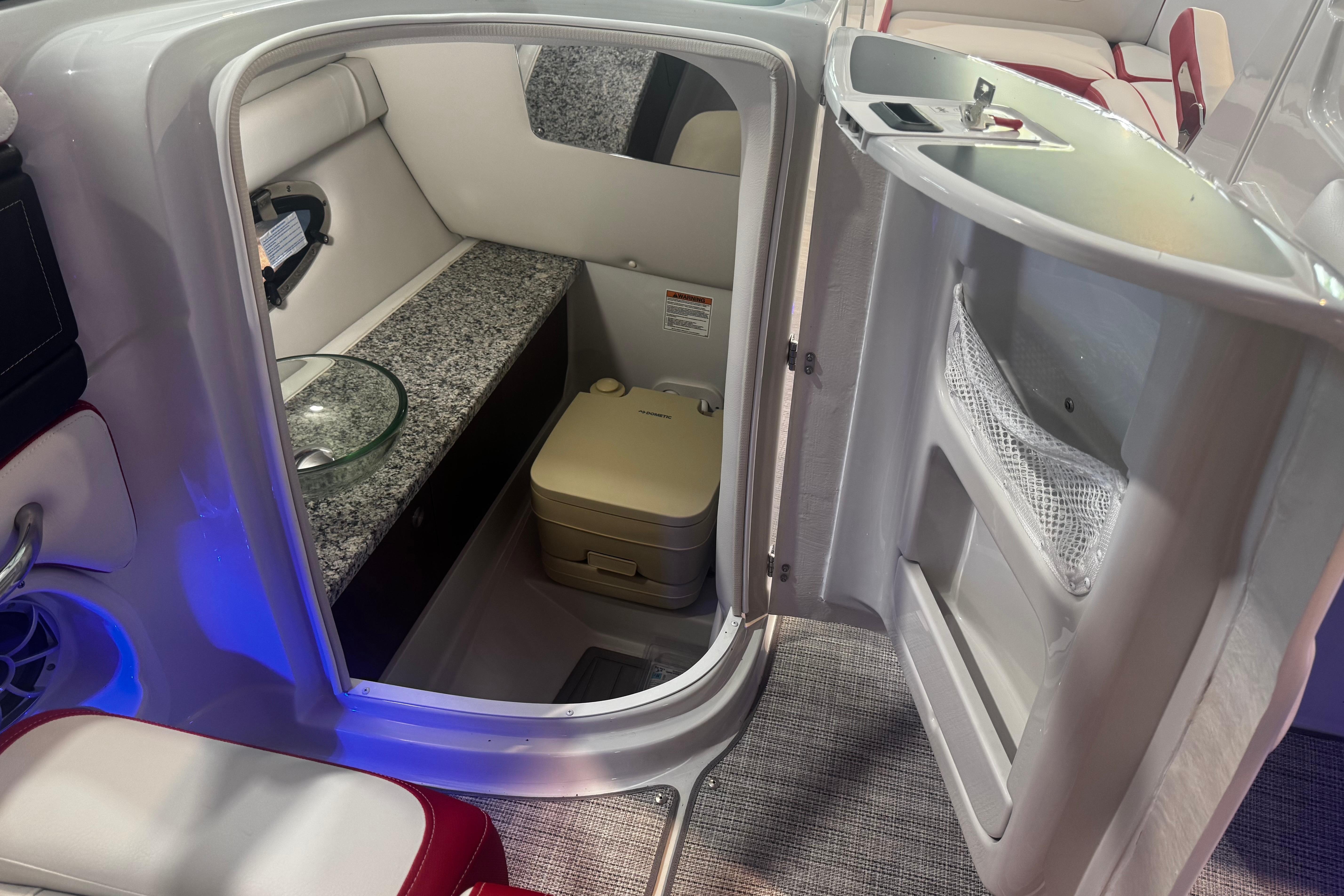2024 Crownline 250 XSS boat interior with compact bathroom and modern amenities.