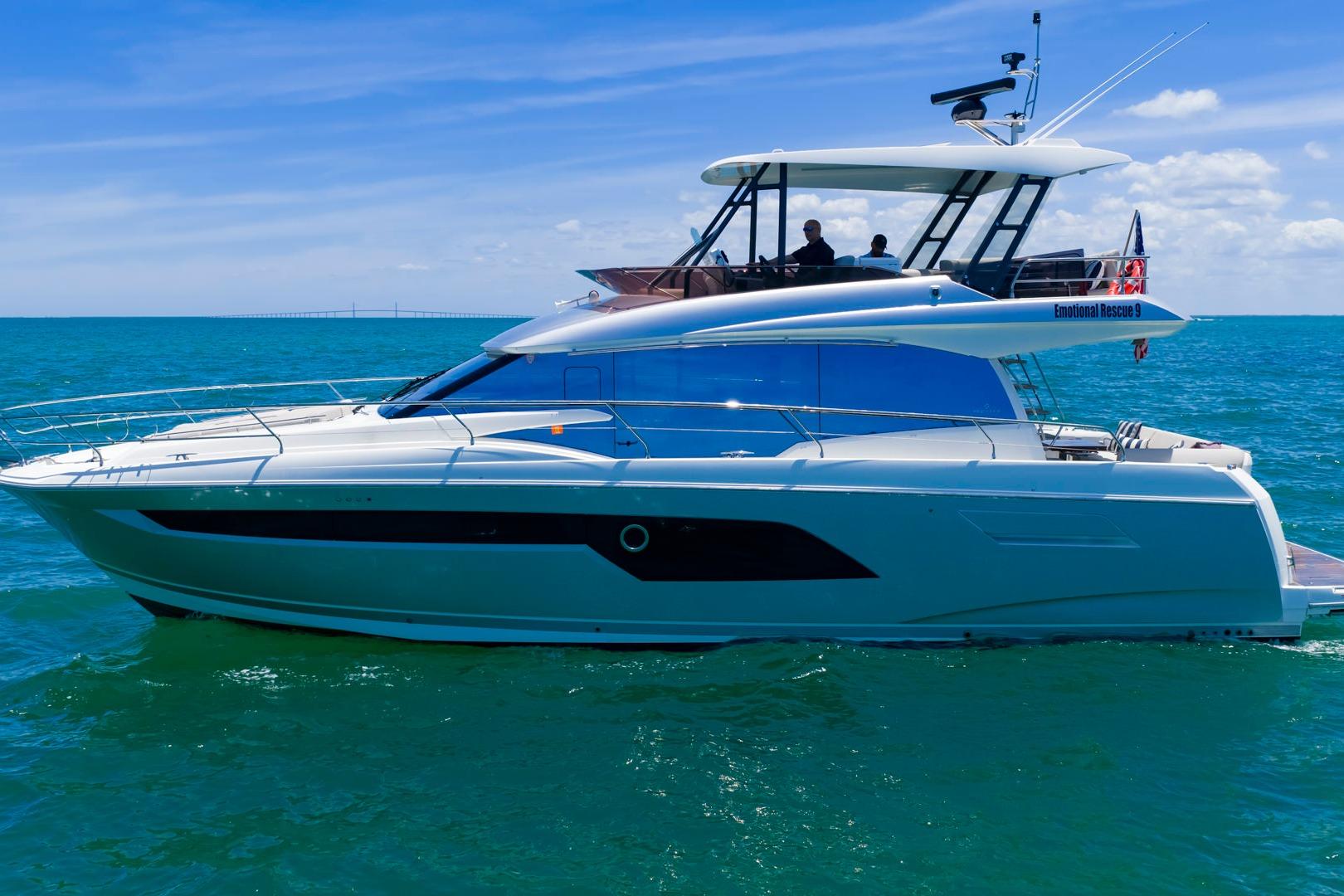 2022 Prestige 520 yacht cruising on clear blue ocean waters.