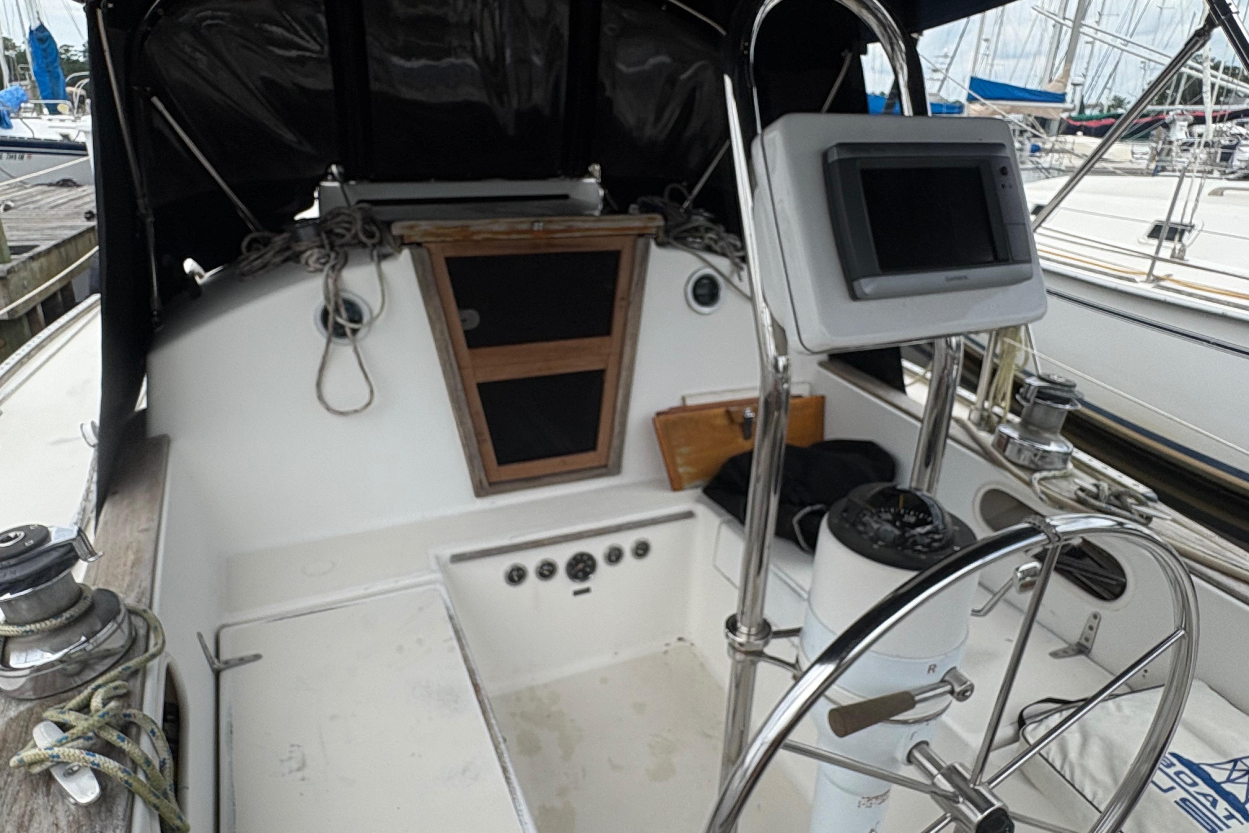 Cockpit of 1981 Sabre 31 sailboat with steering wheel and navigation equipment.