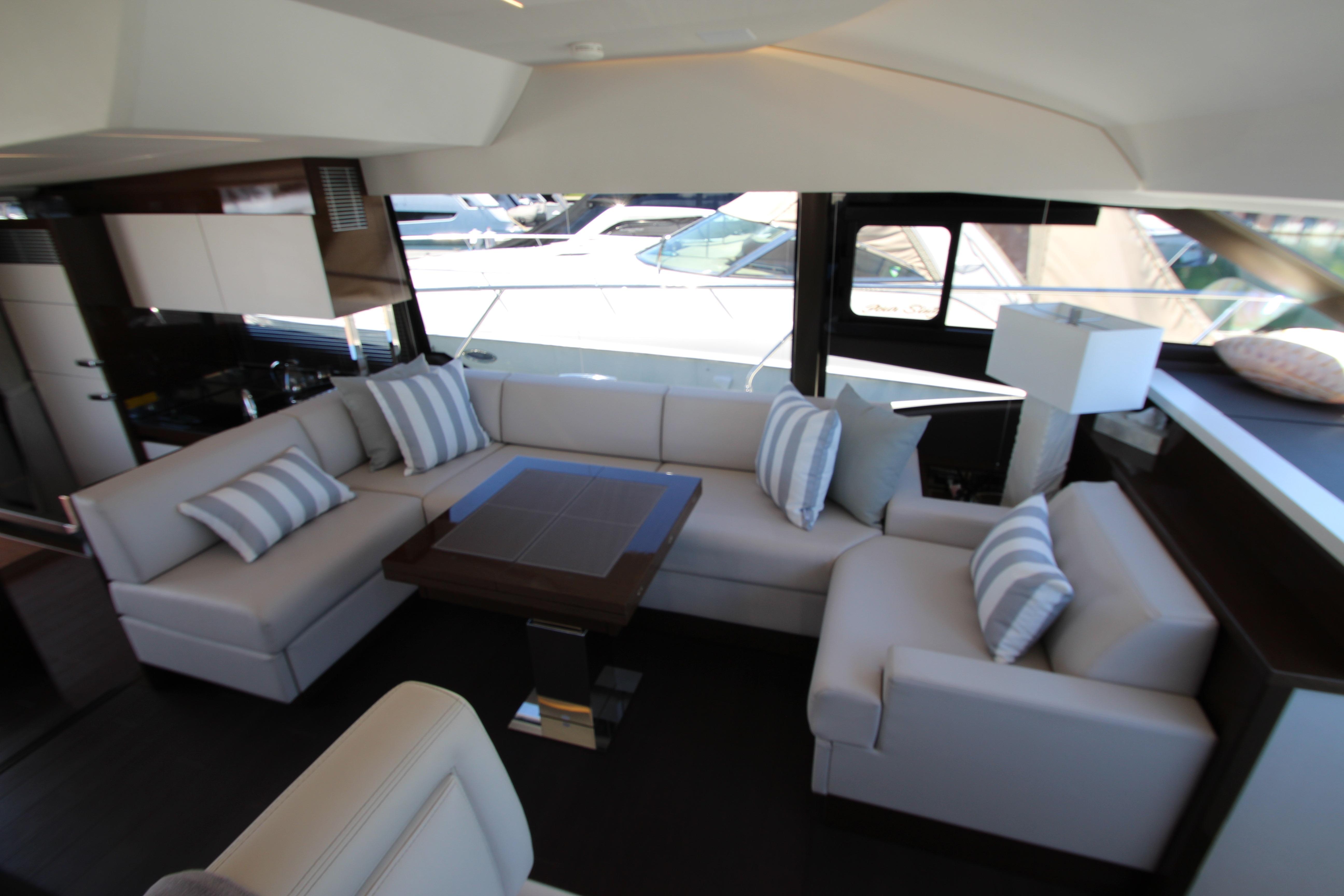 Luxurious interior of 2022 Prestige 520 yacht with elegant seating and modern decor.