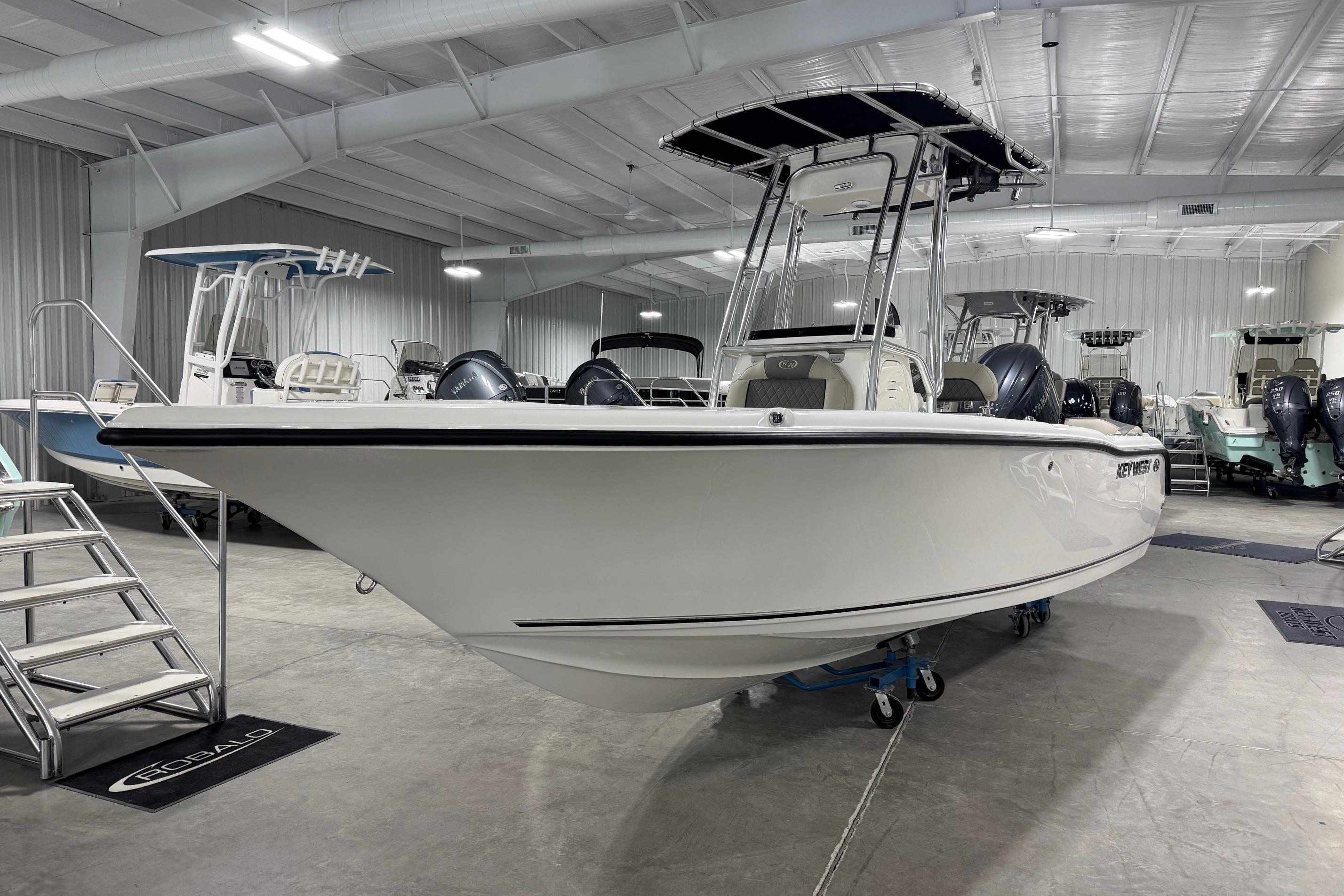 2026 Key West 203 FS boat in showroom, sleek design, white hull, modern interior.