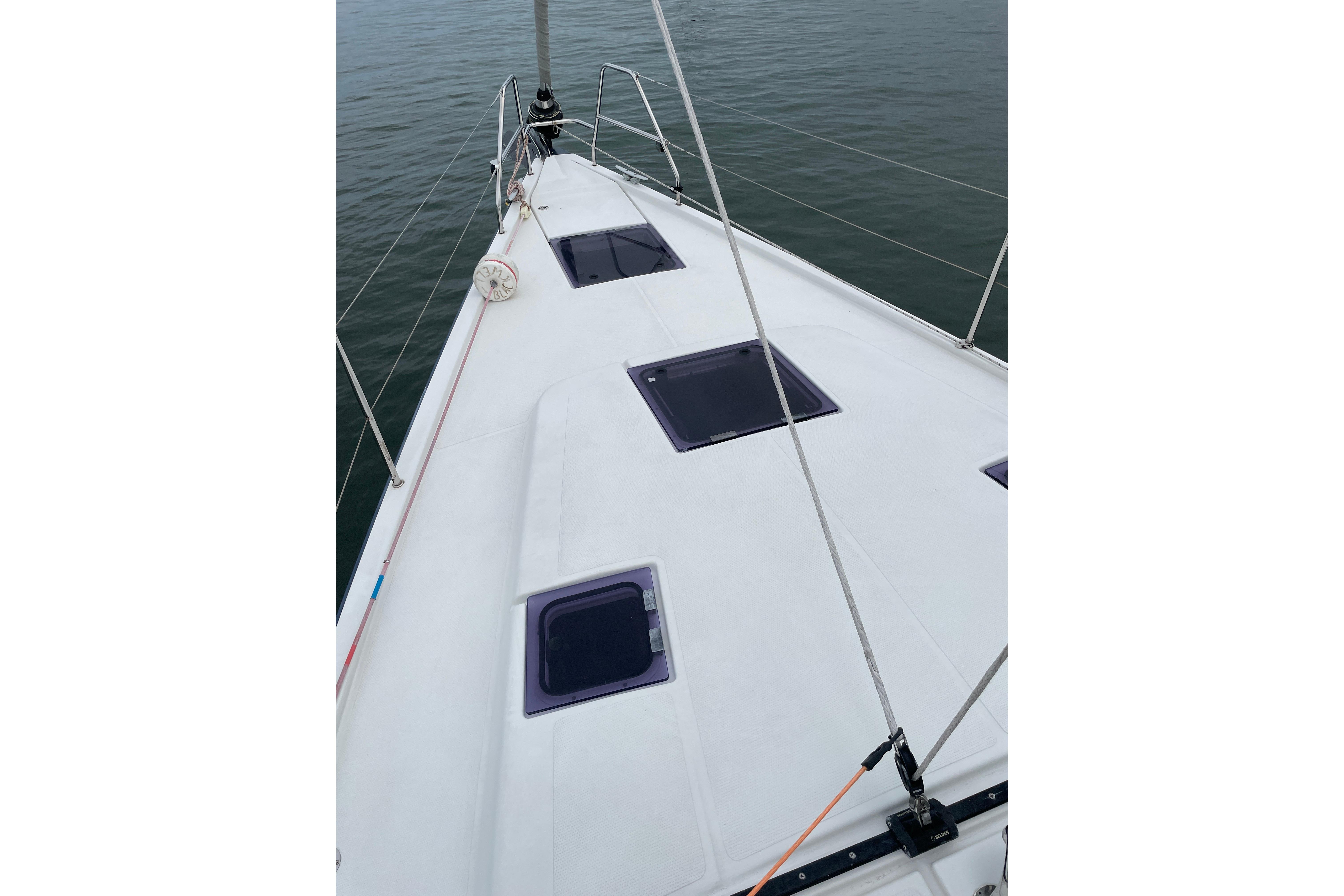 Deck view of a 2014 Hanse 415 sailboat on calm water.